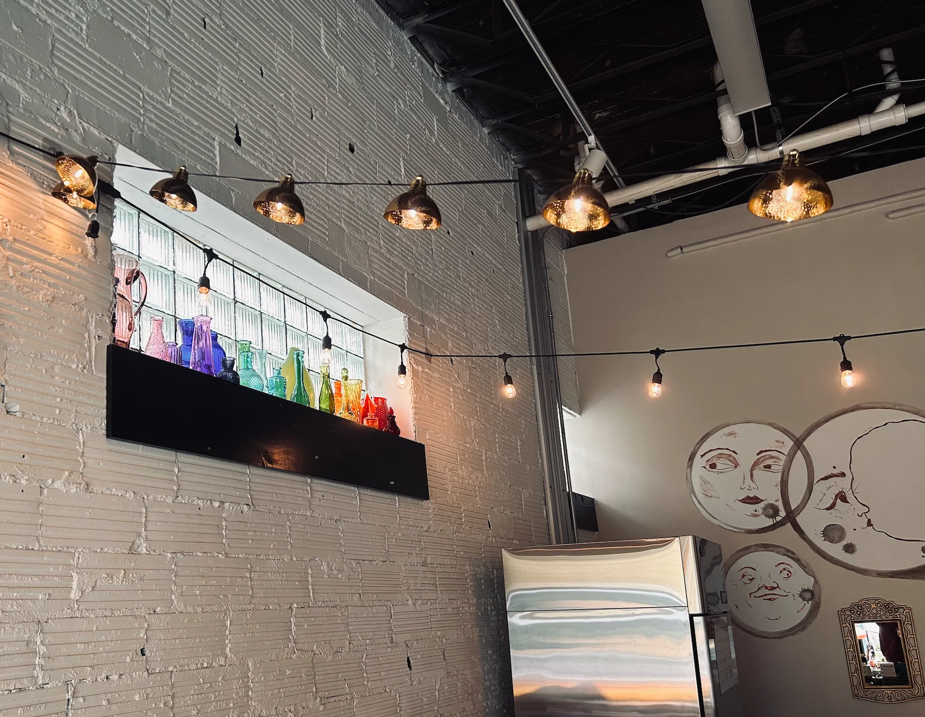 Charming restaurant interior with colorful glass bottles and warm lighting