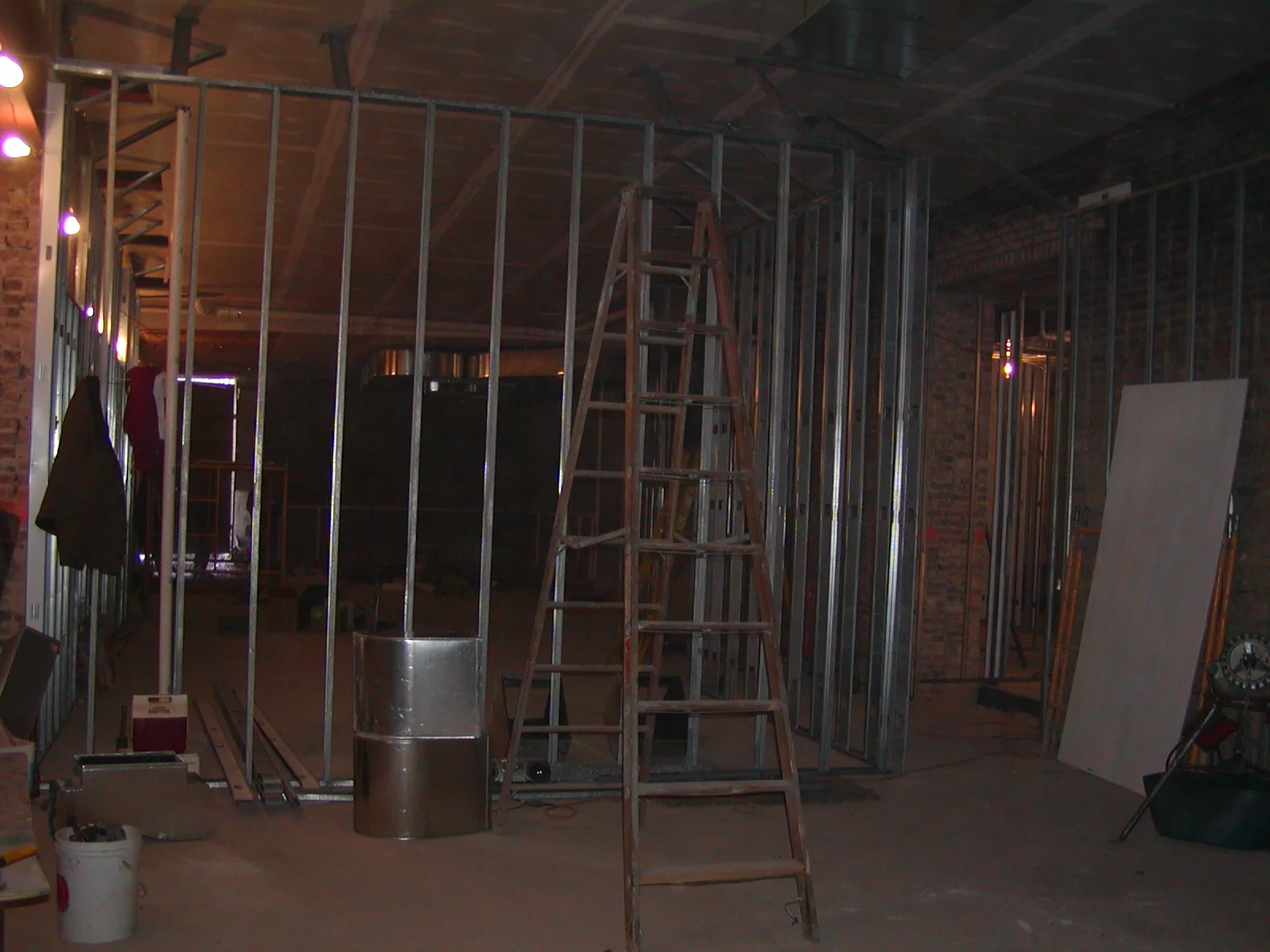 Construction site with metal framing and a ladder in an unfinished space