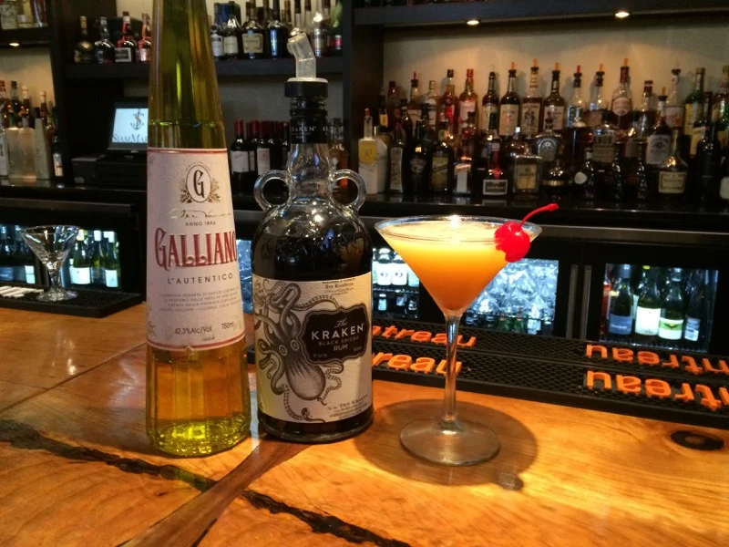 Crafted cocktail with rum and liqueur at a stylish bar