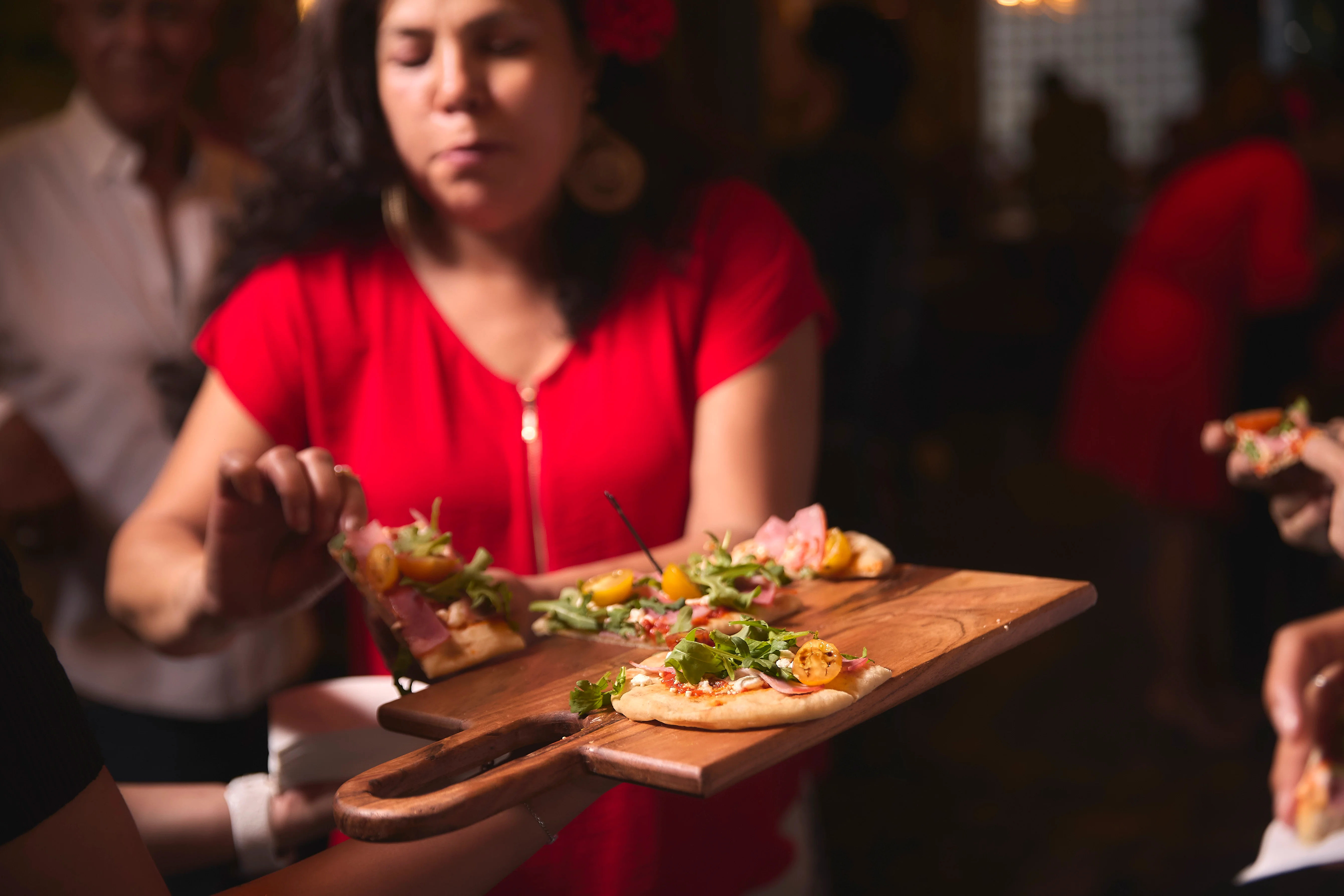 Wood-fired flatbreads served at a vibrant gathering