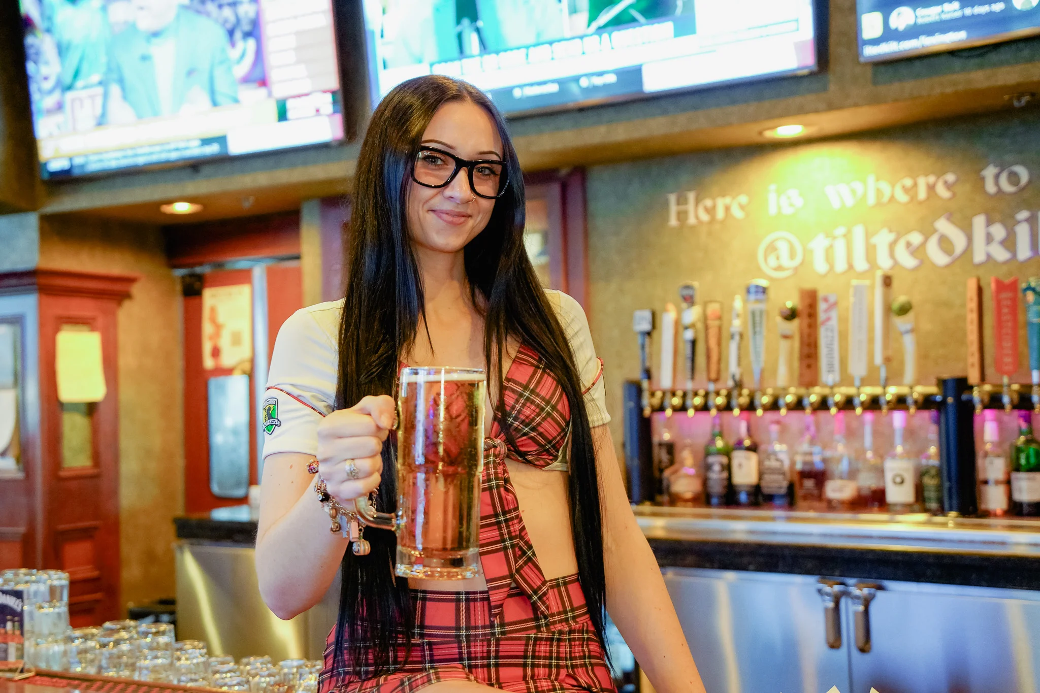 Bartender serving a beer at a lively bar