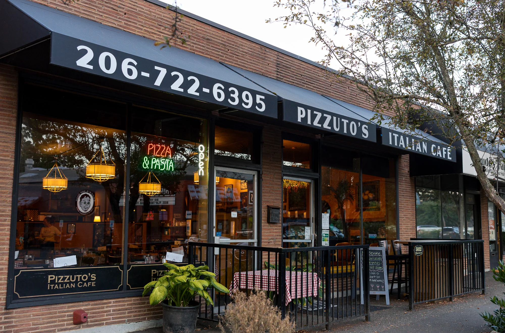 Charming Italian café exterior with pizza and pasta signage
