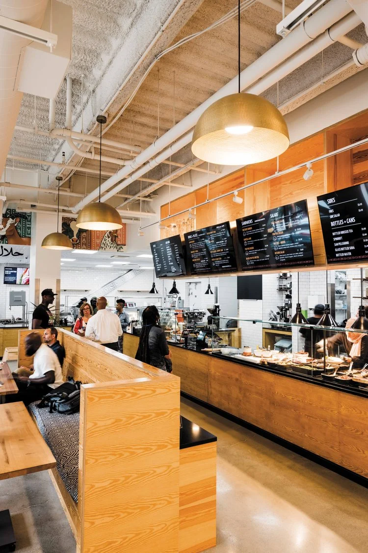 Modern restaurant interior with wooden accents and menu displays