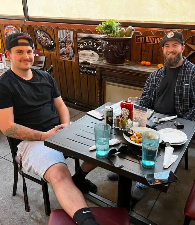Two friends enjoying a meal at a cozy restaurant table