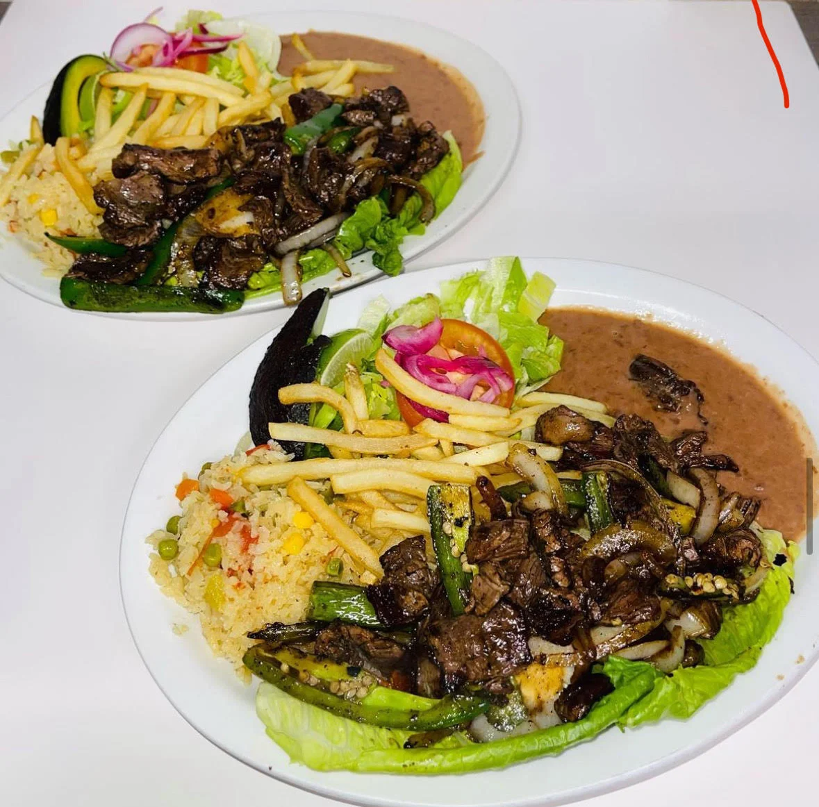 Sizzling fajitas served with rice and beans