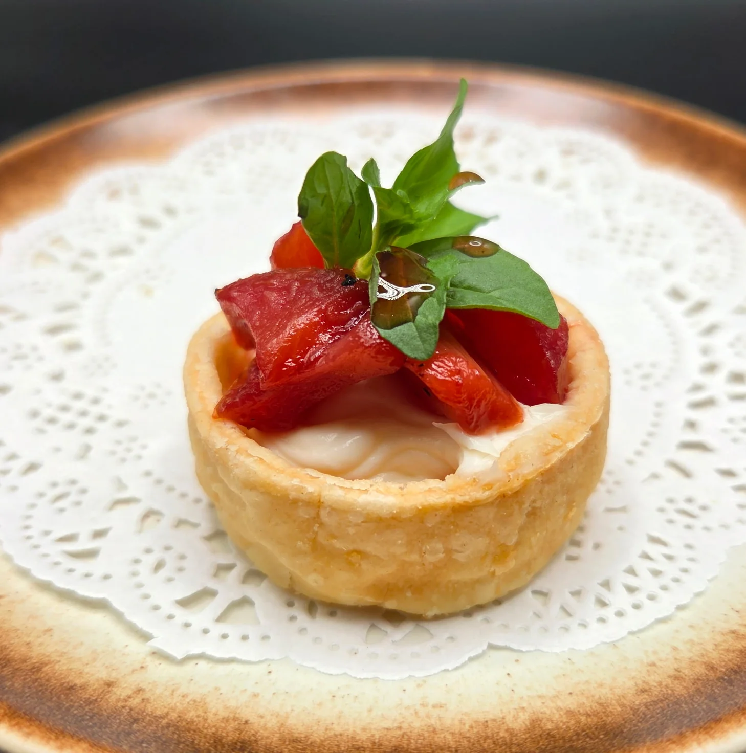 Plate of smoked salmon with garnishes and a decorative presentation.
