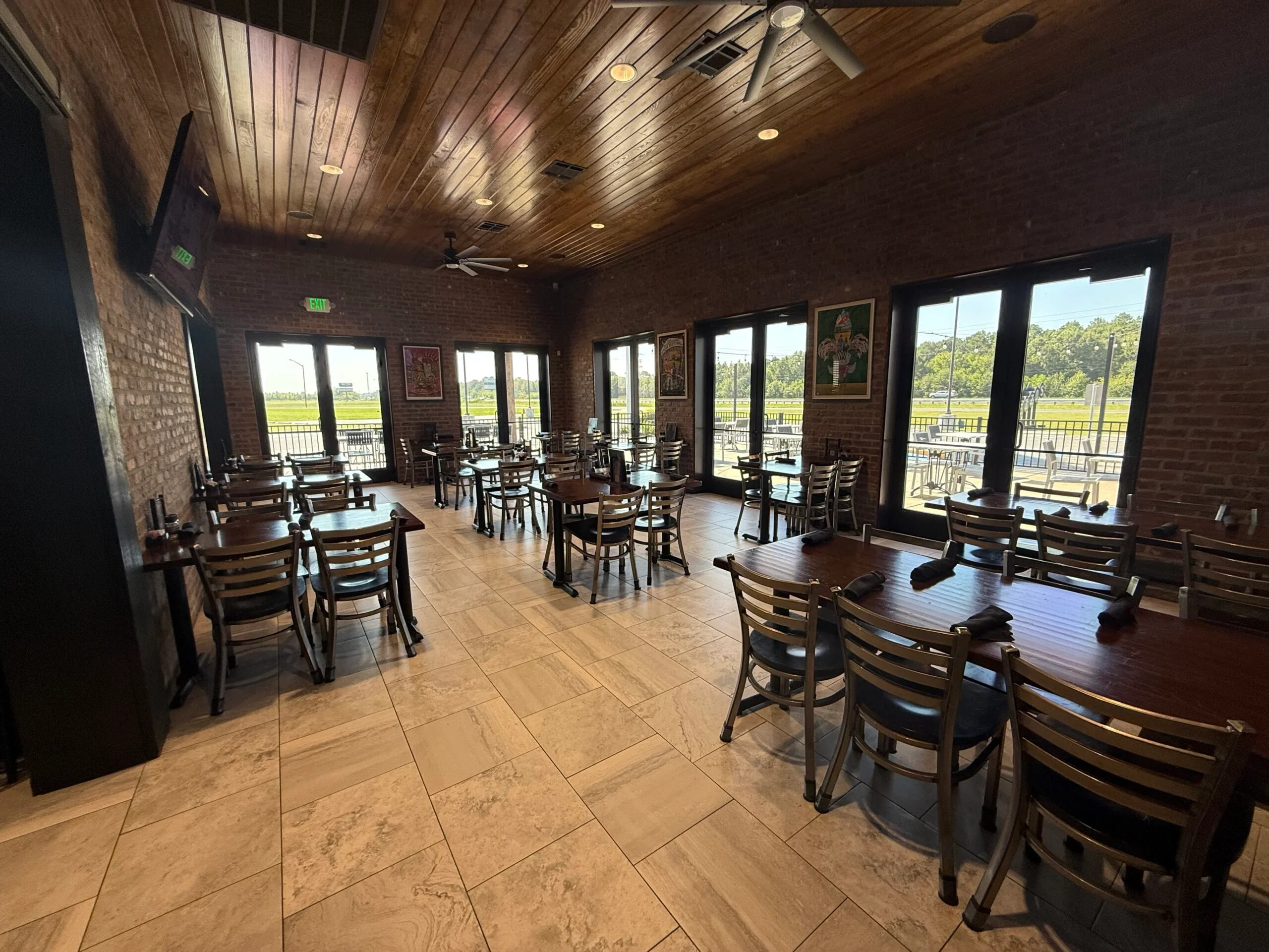 Cozy restaurant interior with exposed brick and large windows