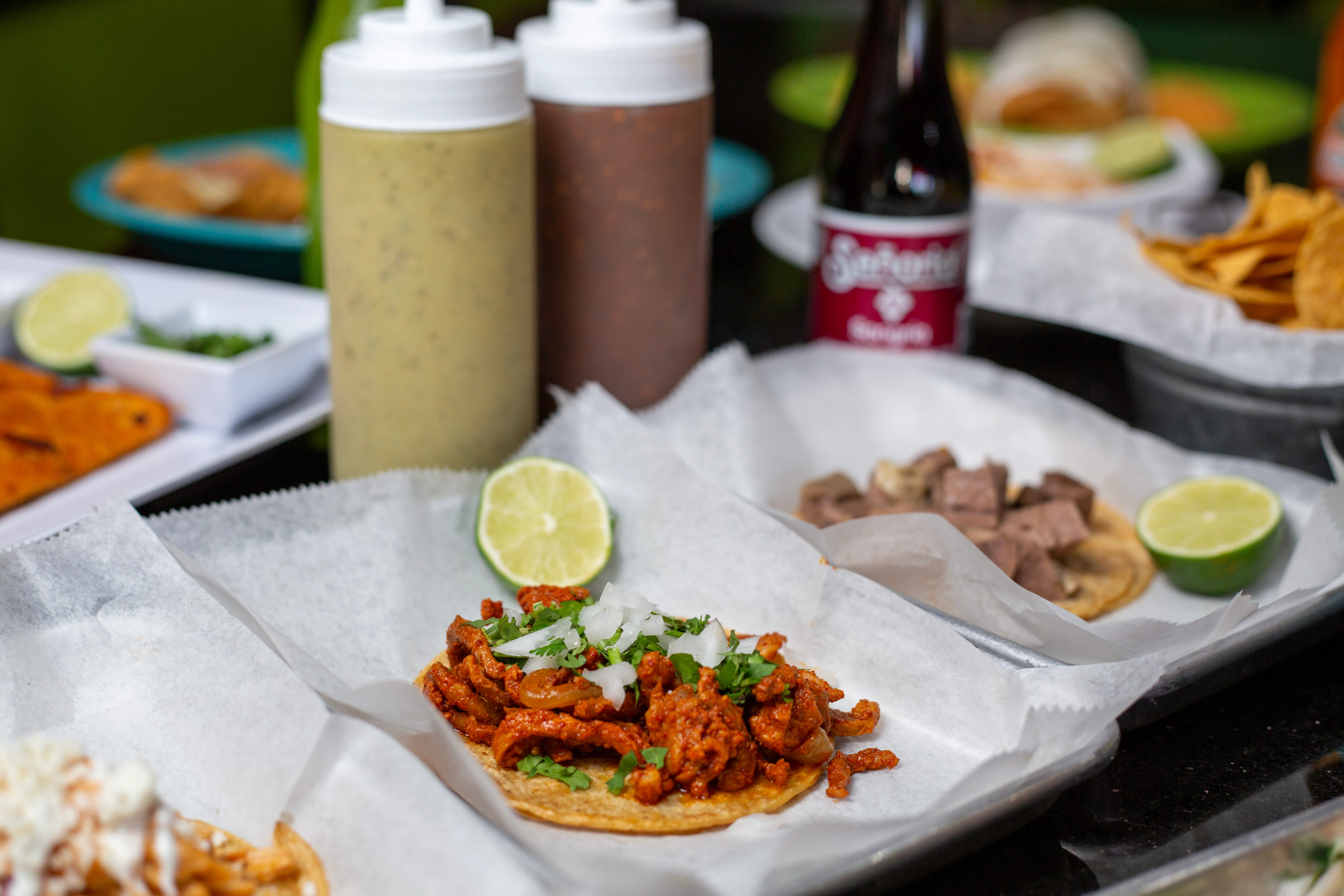 Authentic Mexican tacos al pastor with lime and sauces
