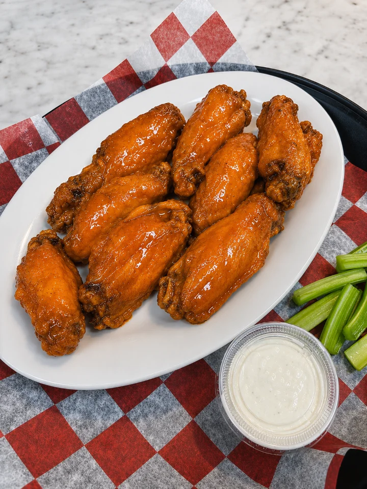 Pasquale’s sauced chicken wings with celery and dipping sauce