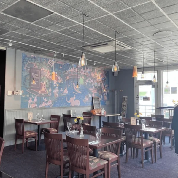 Cozy restaurant interior with artistic mural and warm lighting