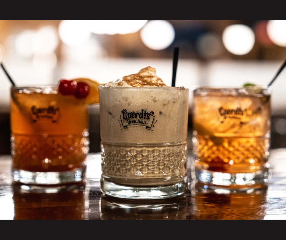 Three cocktails on a bar counter at a brewpub