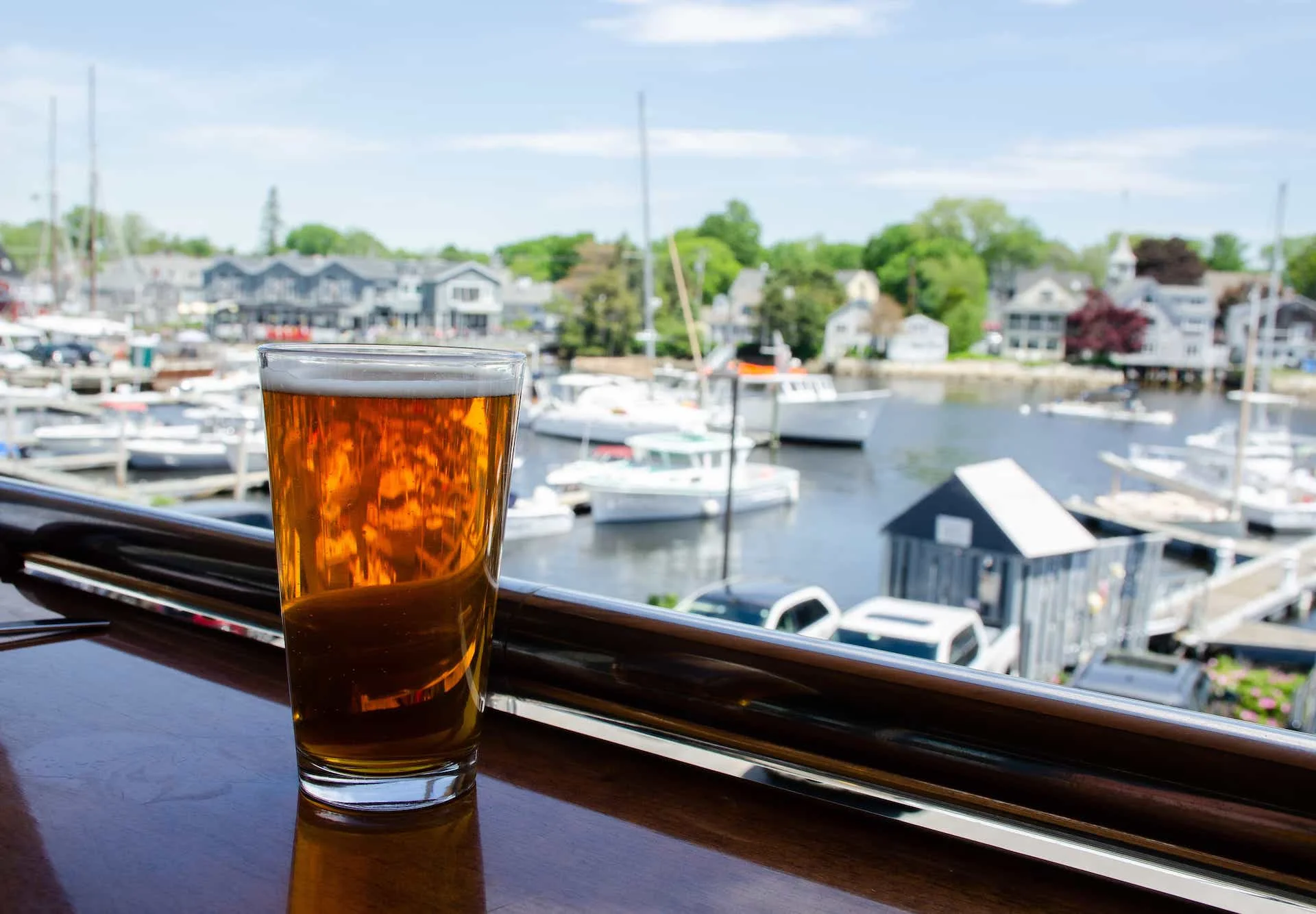 A glass being filled with golden beer, showcasing bubbles and foam.