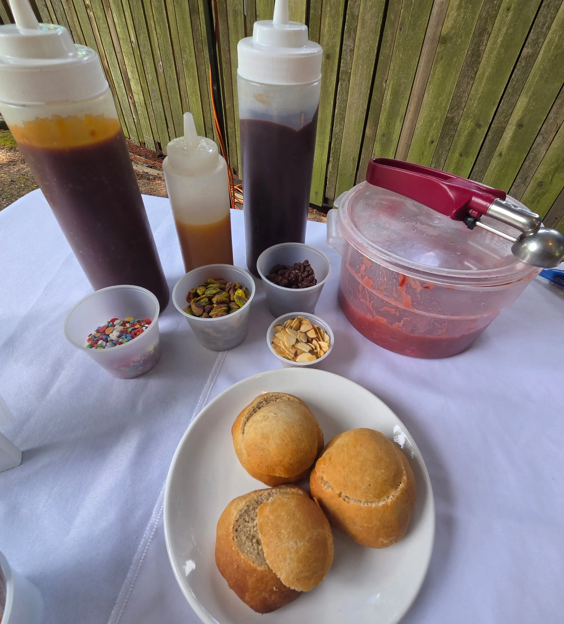 Assorted toppings for ice cream with fresh baked rolls