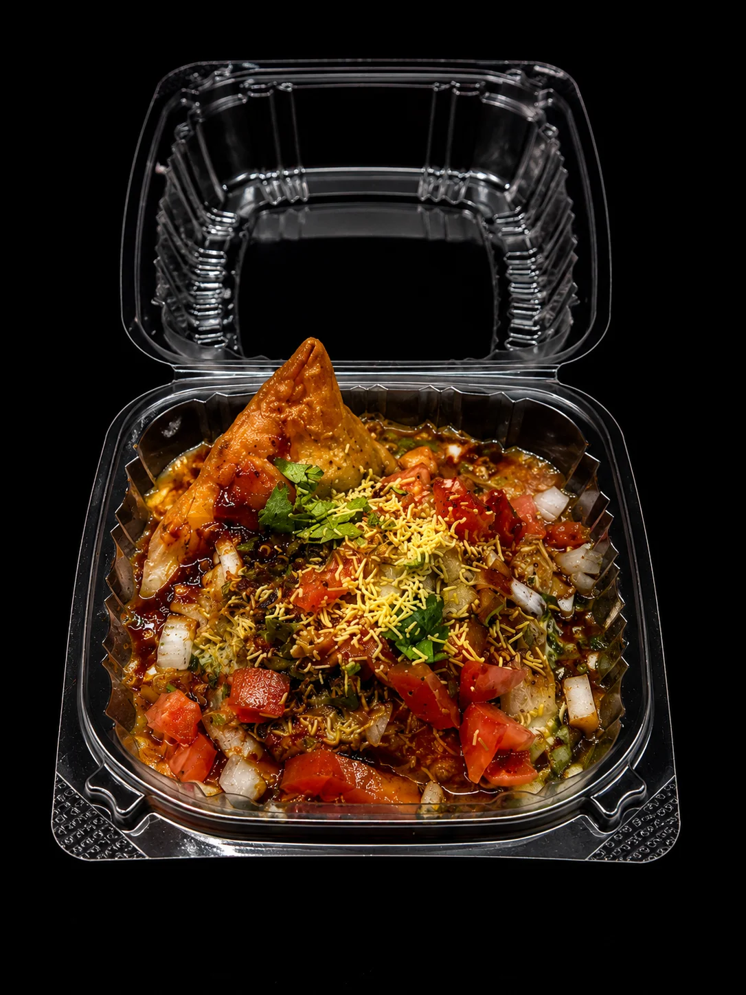 Delicious Indian chaat with samosa and fresh toppings