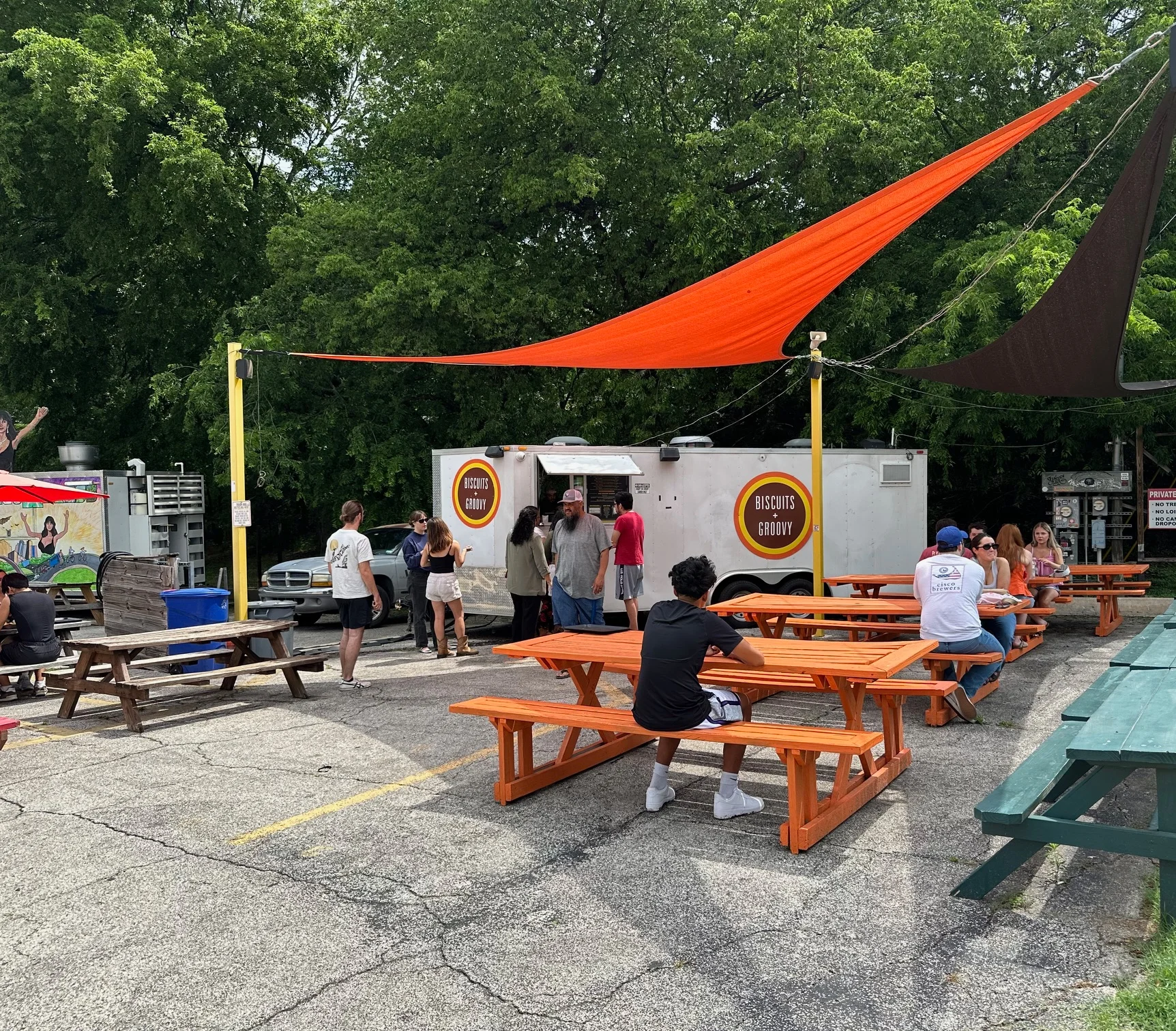 Food truck serving biscuits in a vibrant outdoor seating area