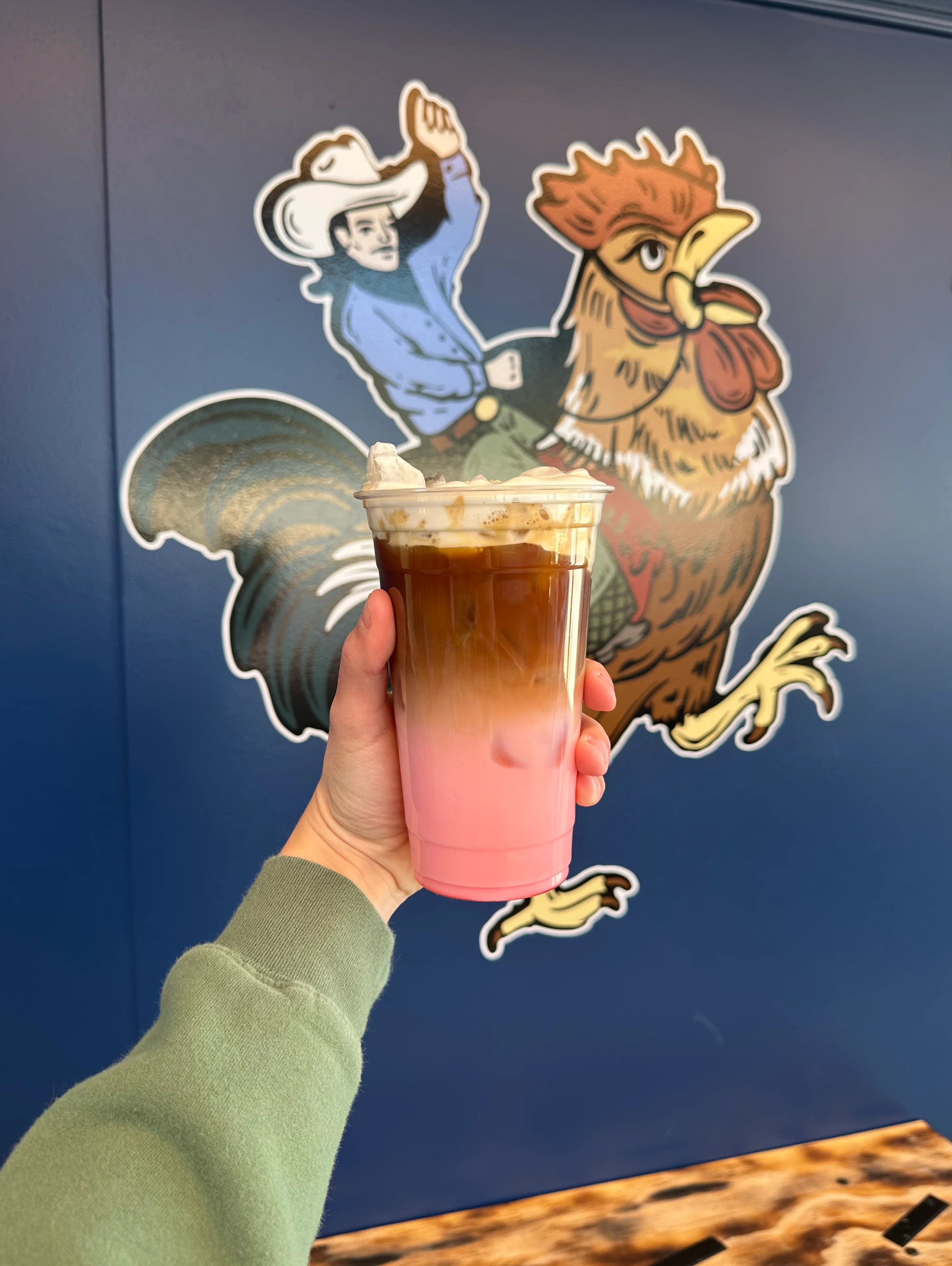 Colorful layered iced coffee drink with whipped cream