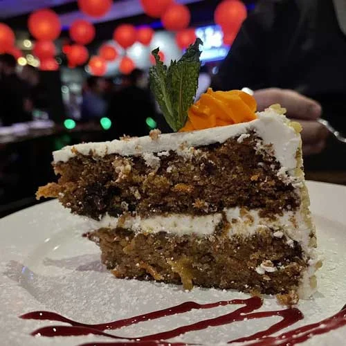 Moist carrot cake slice with cream cheese frosting