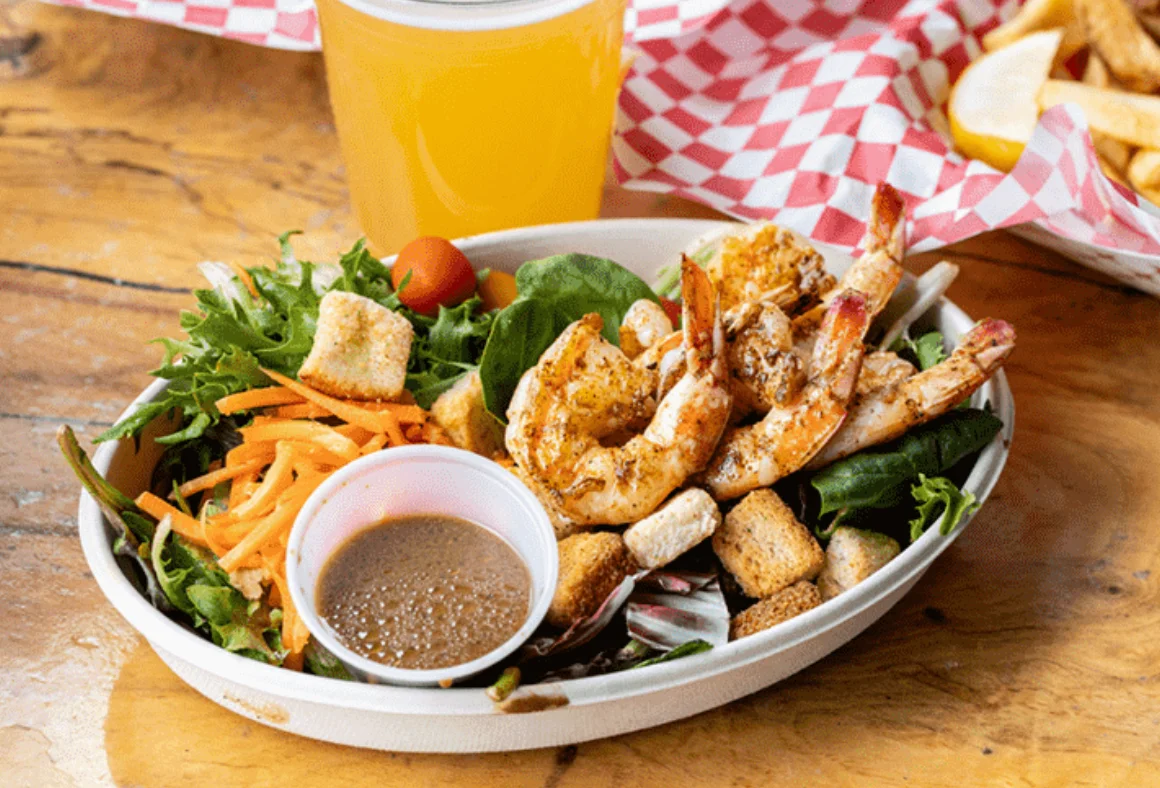 Cajun shrimp salad with mixed greens and dressing