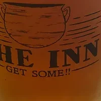 Chilled beer in a branded mug on a wooden table