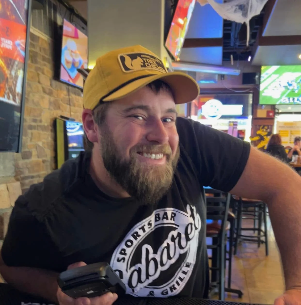 Smiling bartender at a lively sports bar