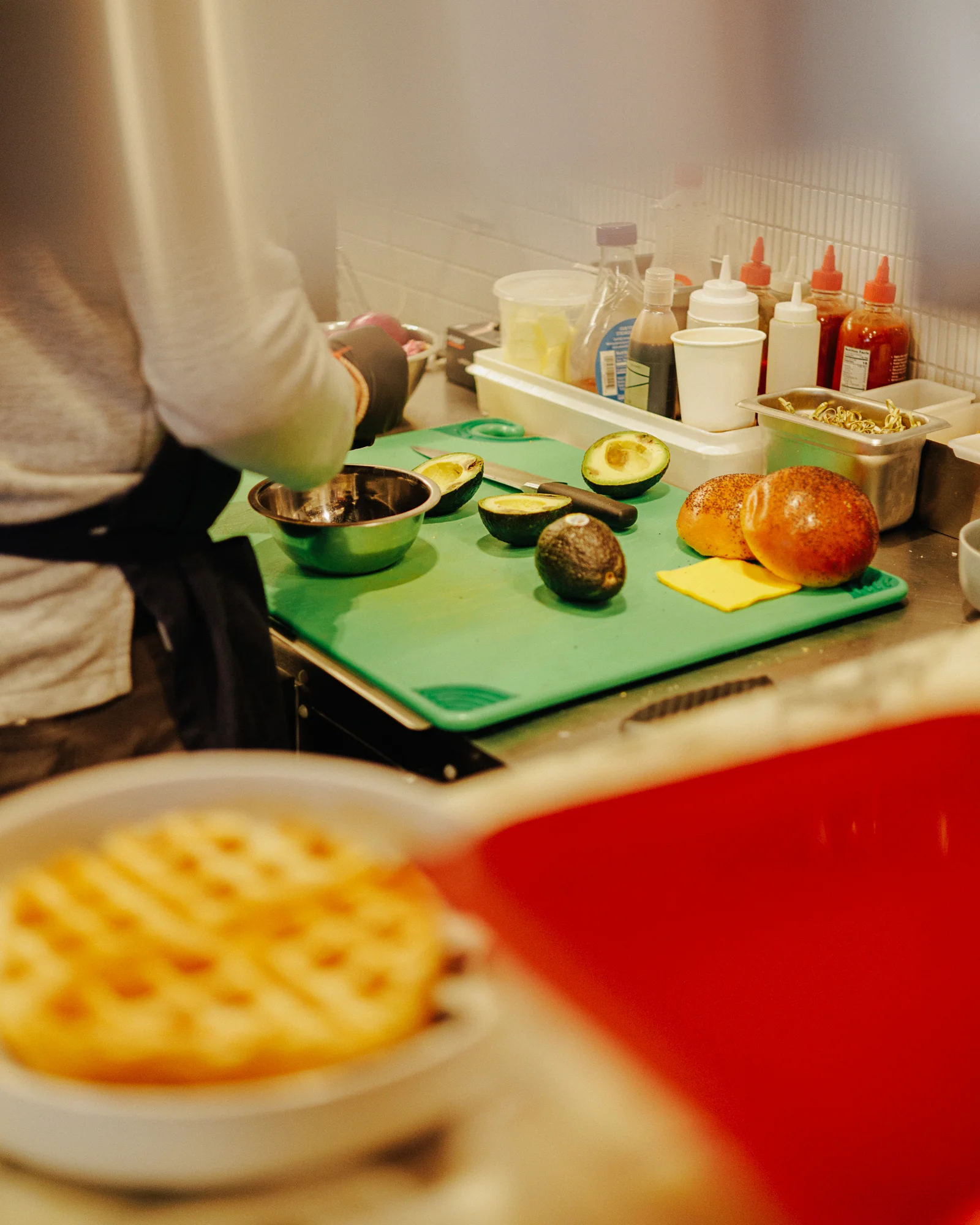Chef preparing fresh guacamole in a vibrant kitchen