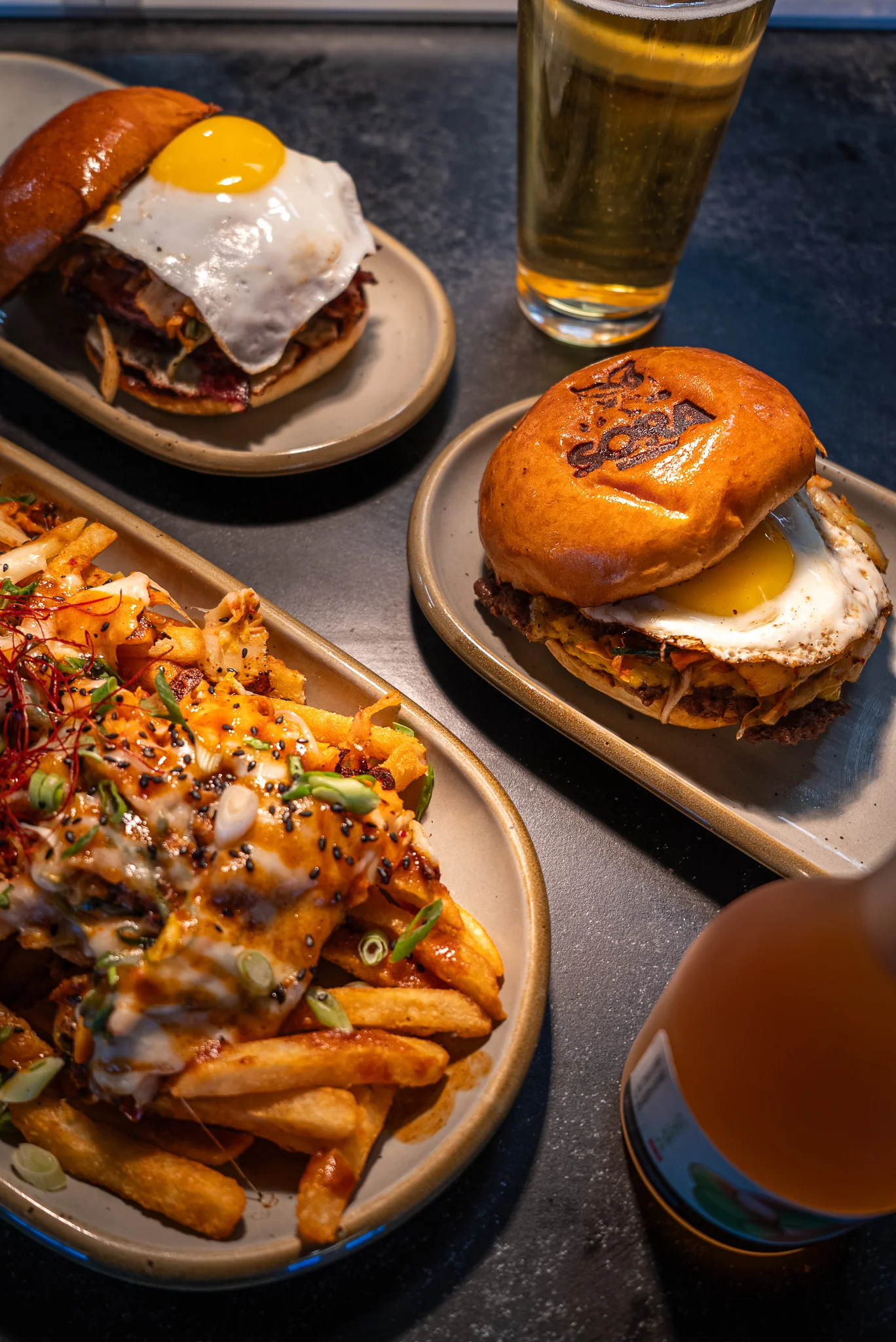 Korean-style burgers with fried egg and loaded fries