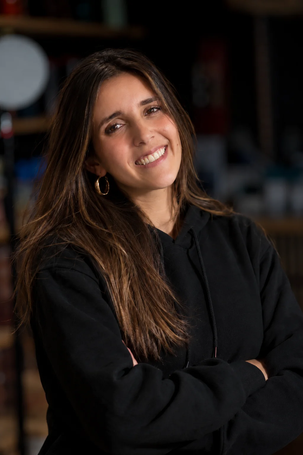 Smiling restaurant staff member portrait in a warm dining room