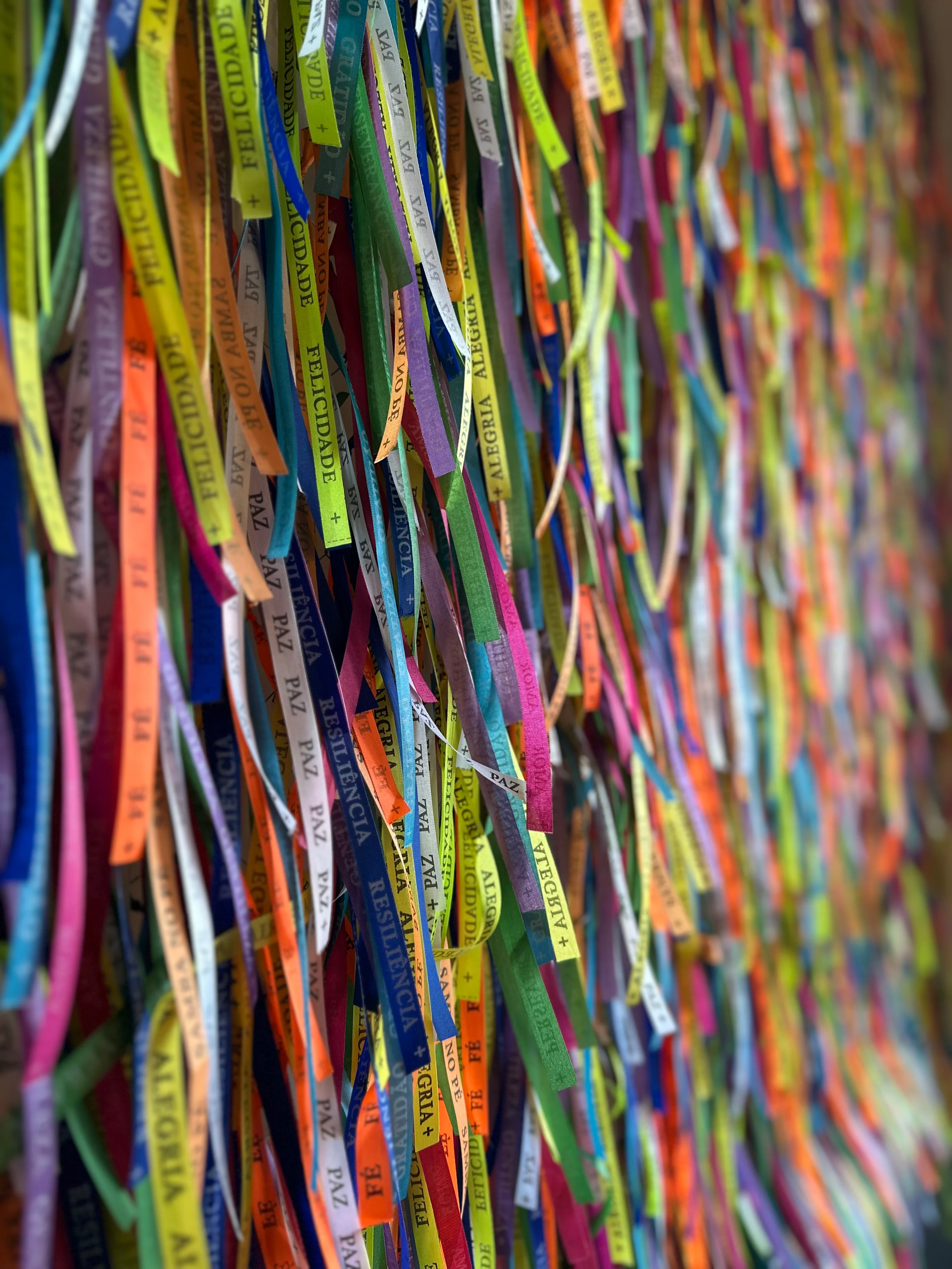 Colorful ribbons with positive messages hanging on a wall