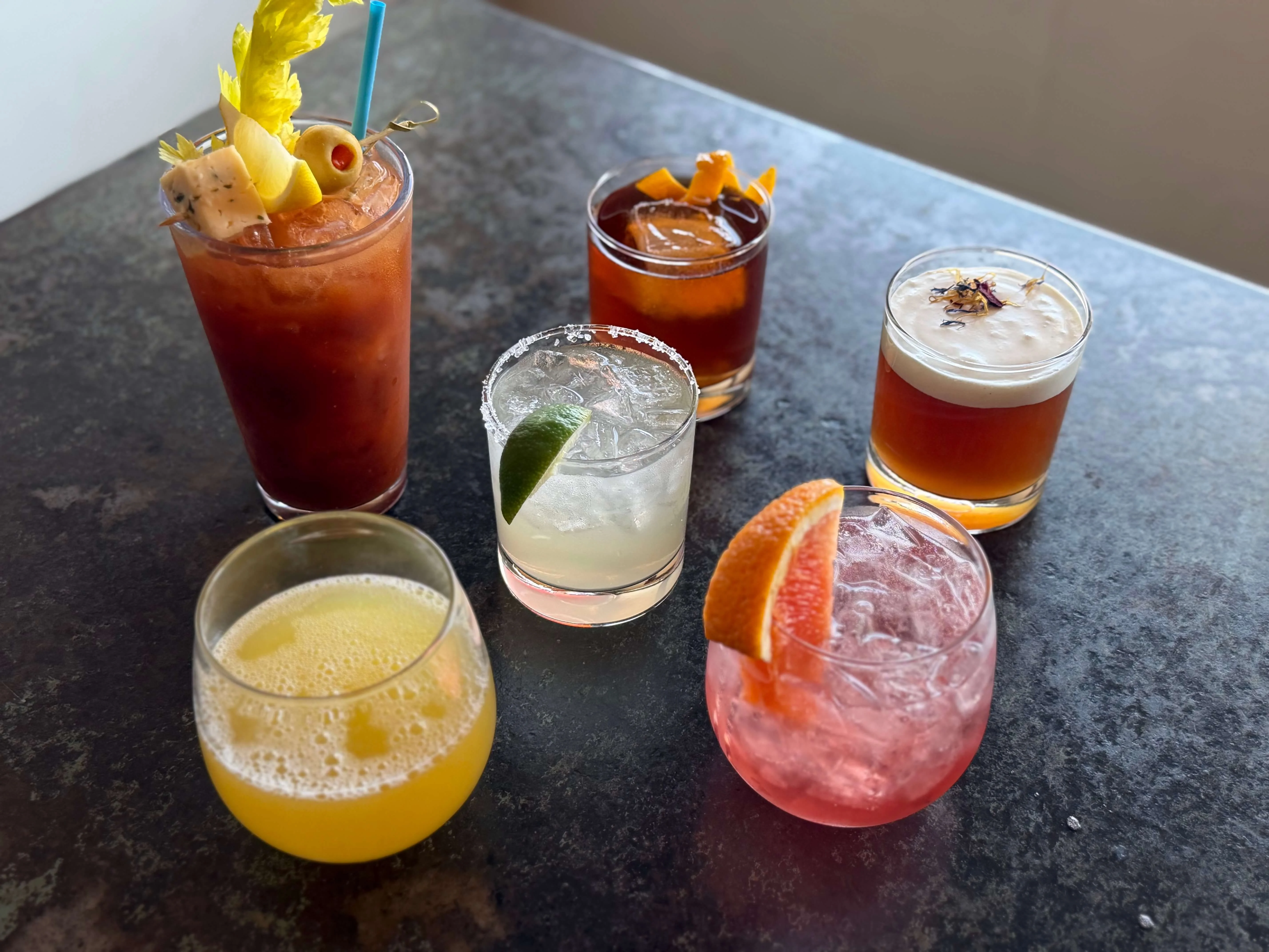 Variety of colorful cocktails on a bar counter