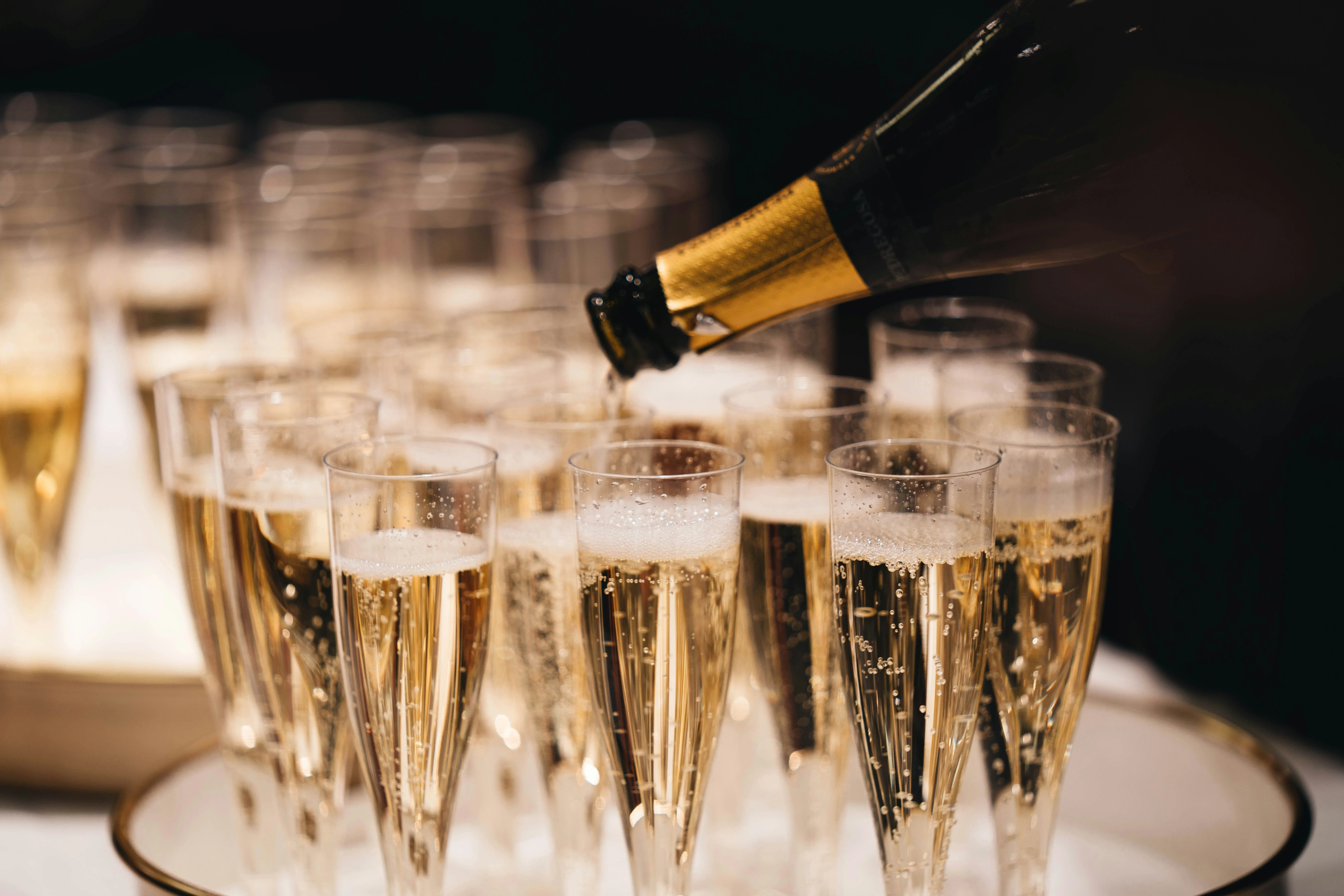 Pouring champagne into flutes for a celebration