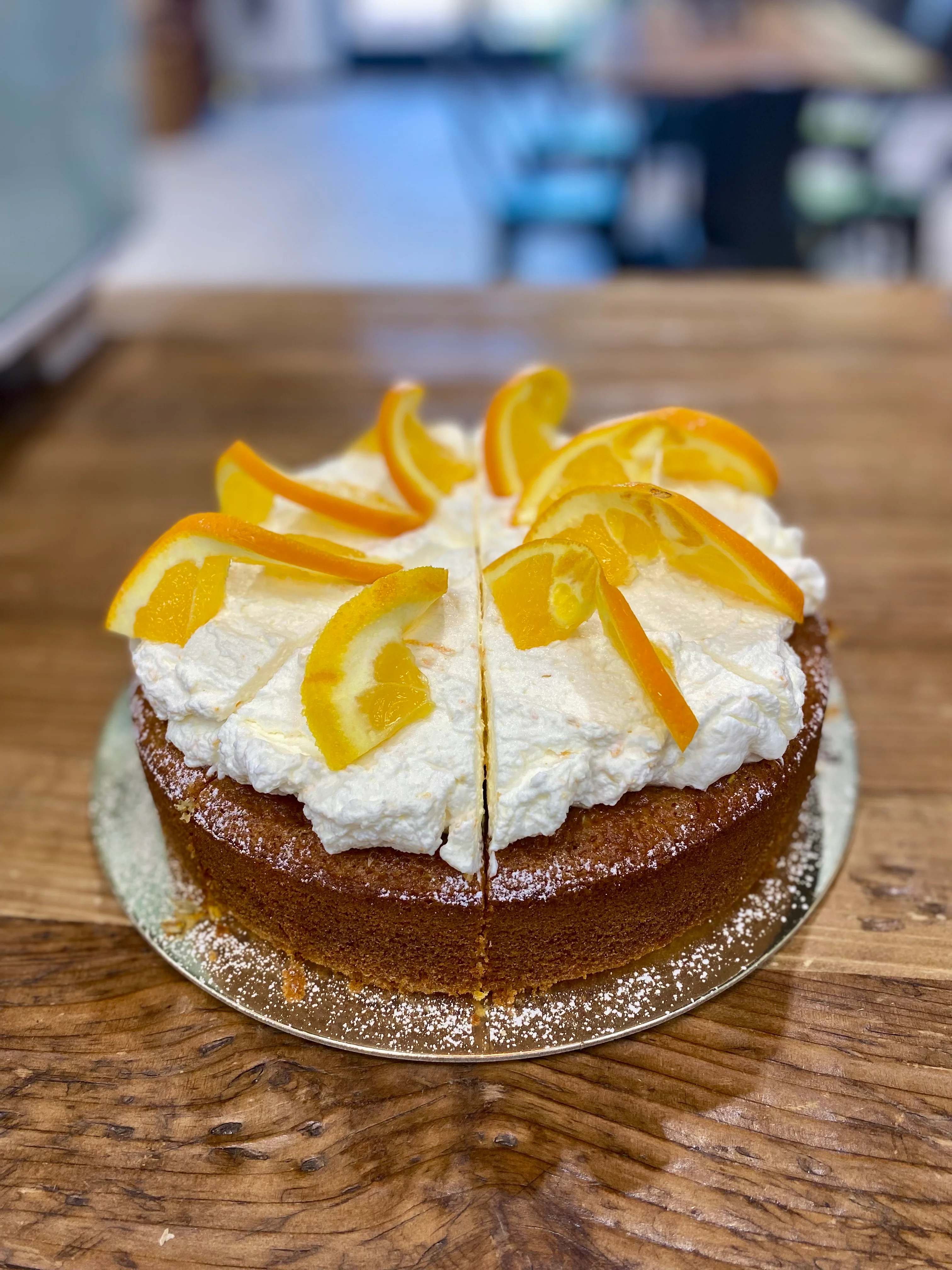 Delicious orange cake topped with whipped cream and citrus slices