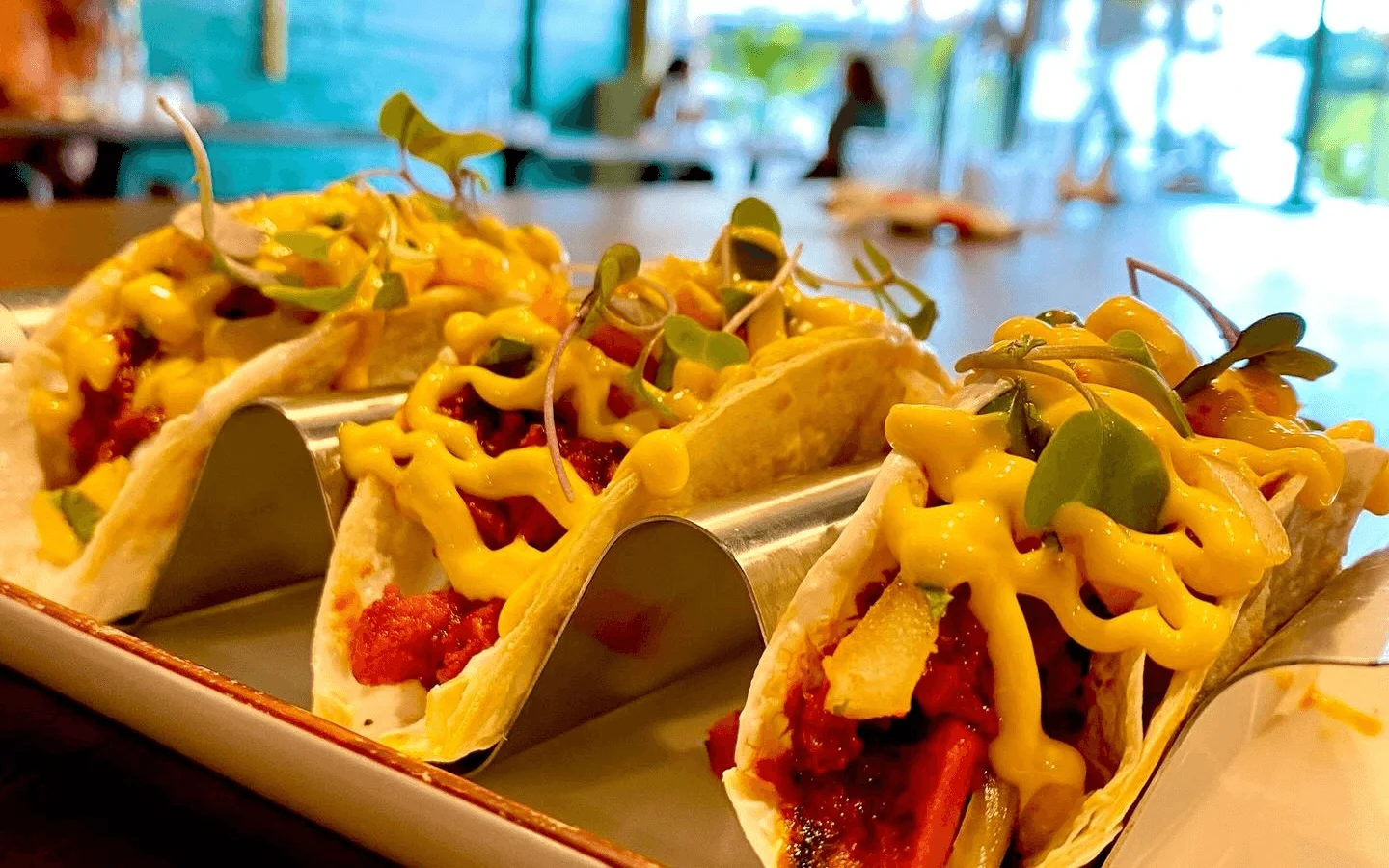Delicious street tacos topped with cheese and microgreens