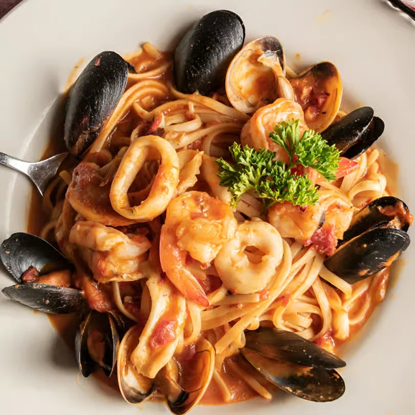 Linguine with shrimp, mussels, calamari, and herbs in a light seafood sauce.