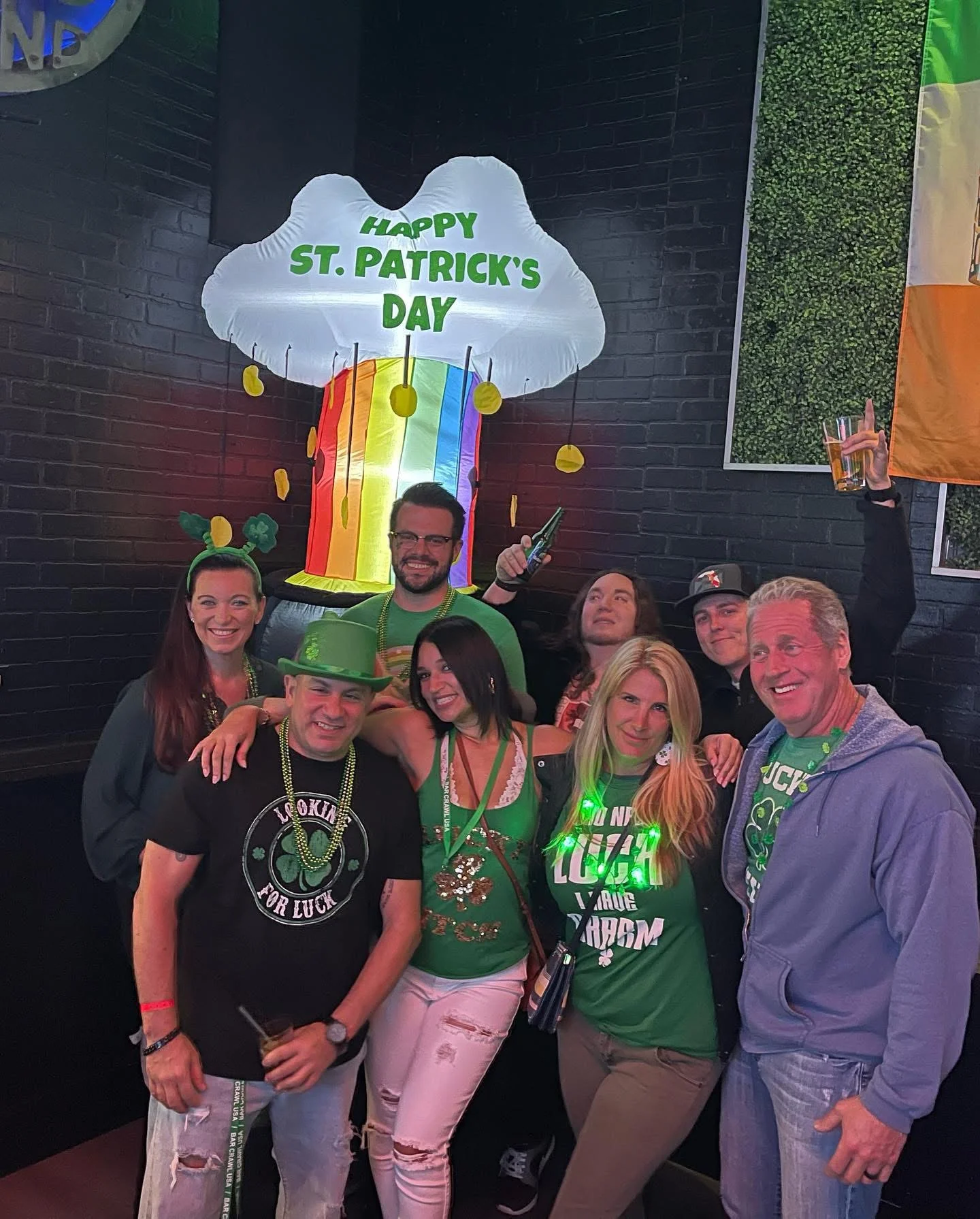 Group celebrating St. Patrick's Day with festive decorations and drinks