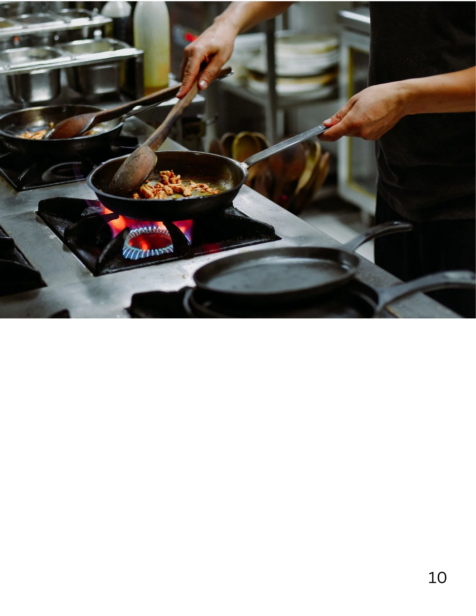 Chef sautéing ingredients in a busy restaurant kitchen