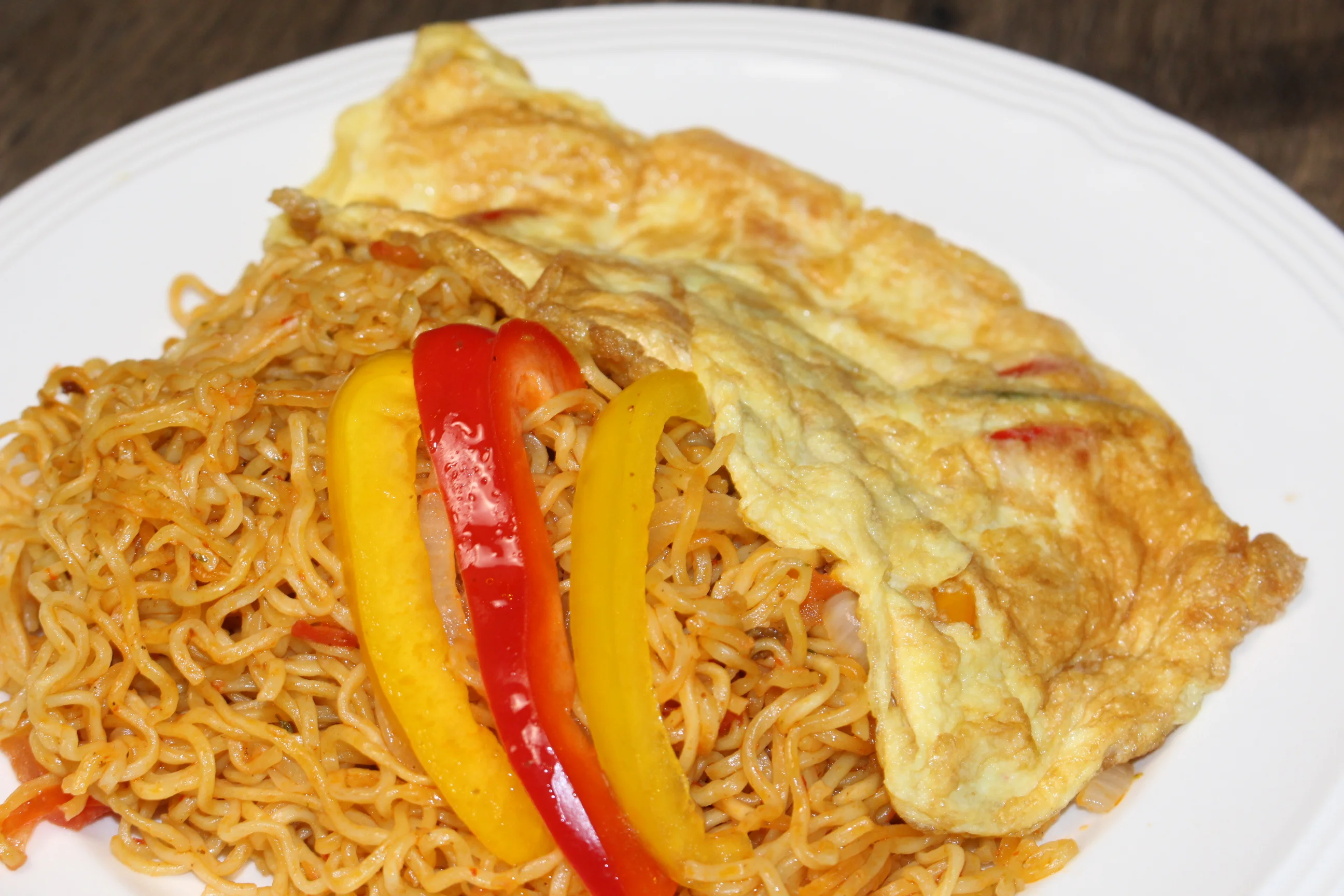 Indonesian fried noodles topped with an omelette