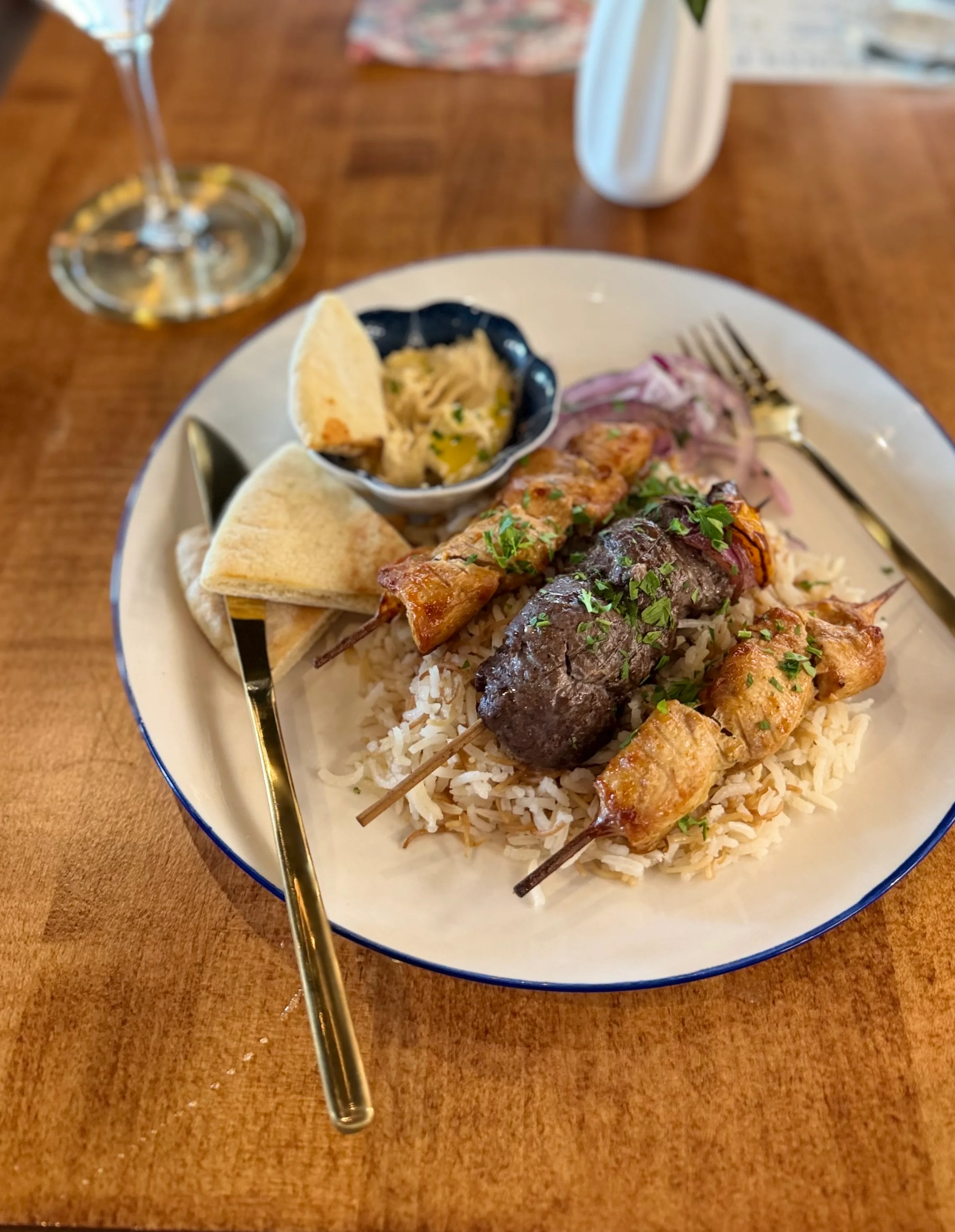Middle Eastern kebab platter with rice and pita bread