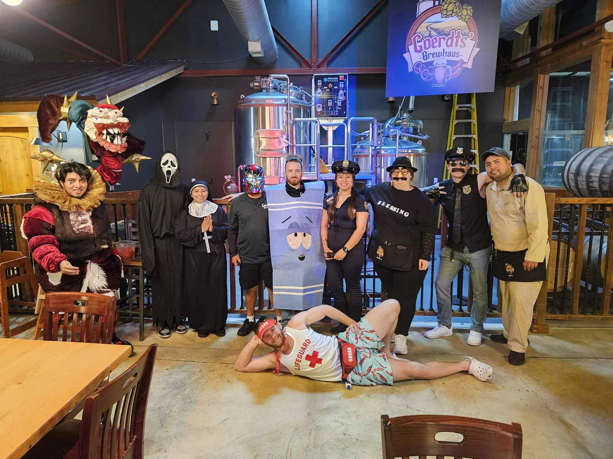 Costumed staff posing in a brewery for a fun event