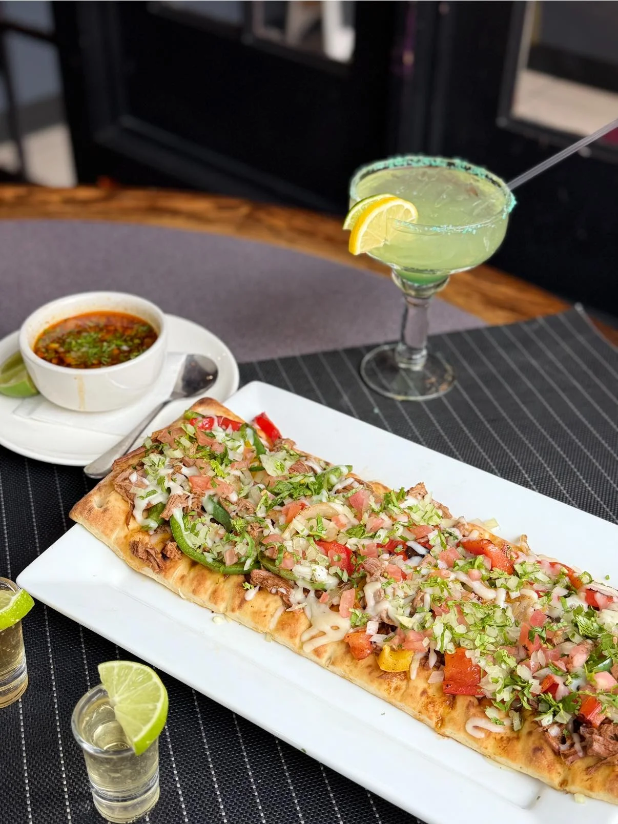 Mexican burrito with fresh toppings and margarita