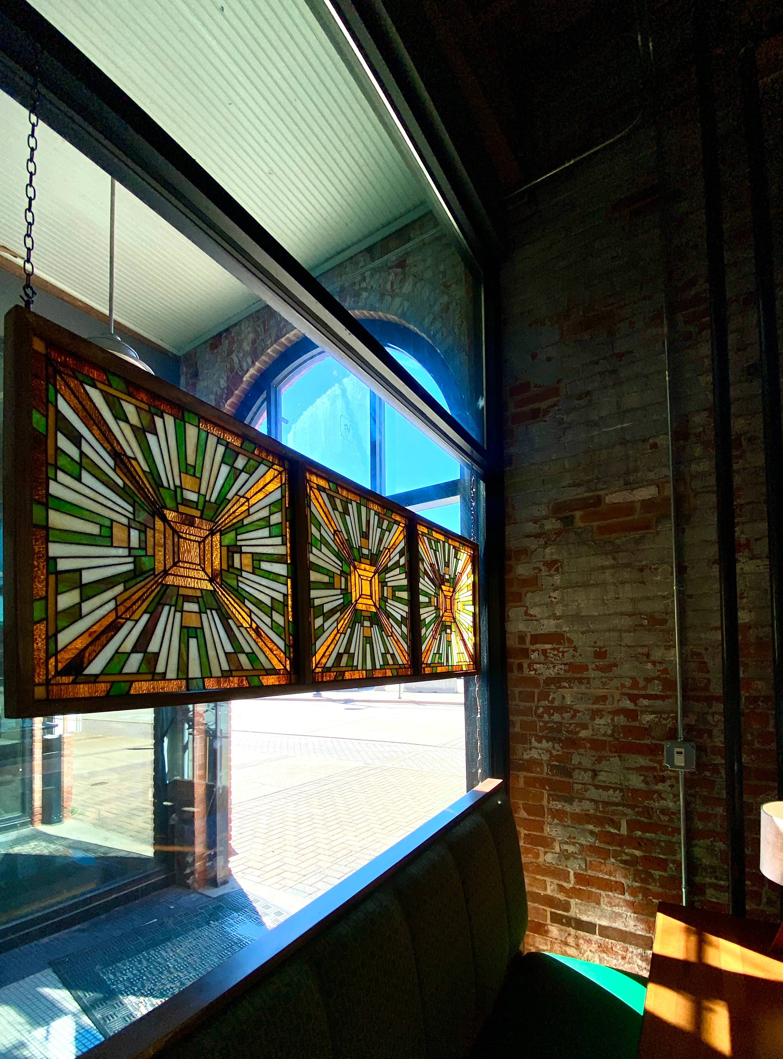 Cozy Snug seating with stained glass art.