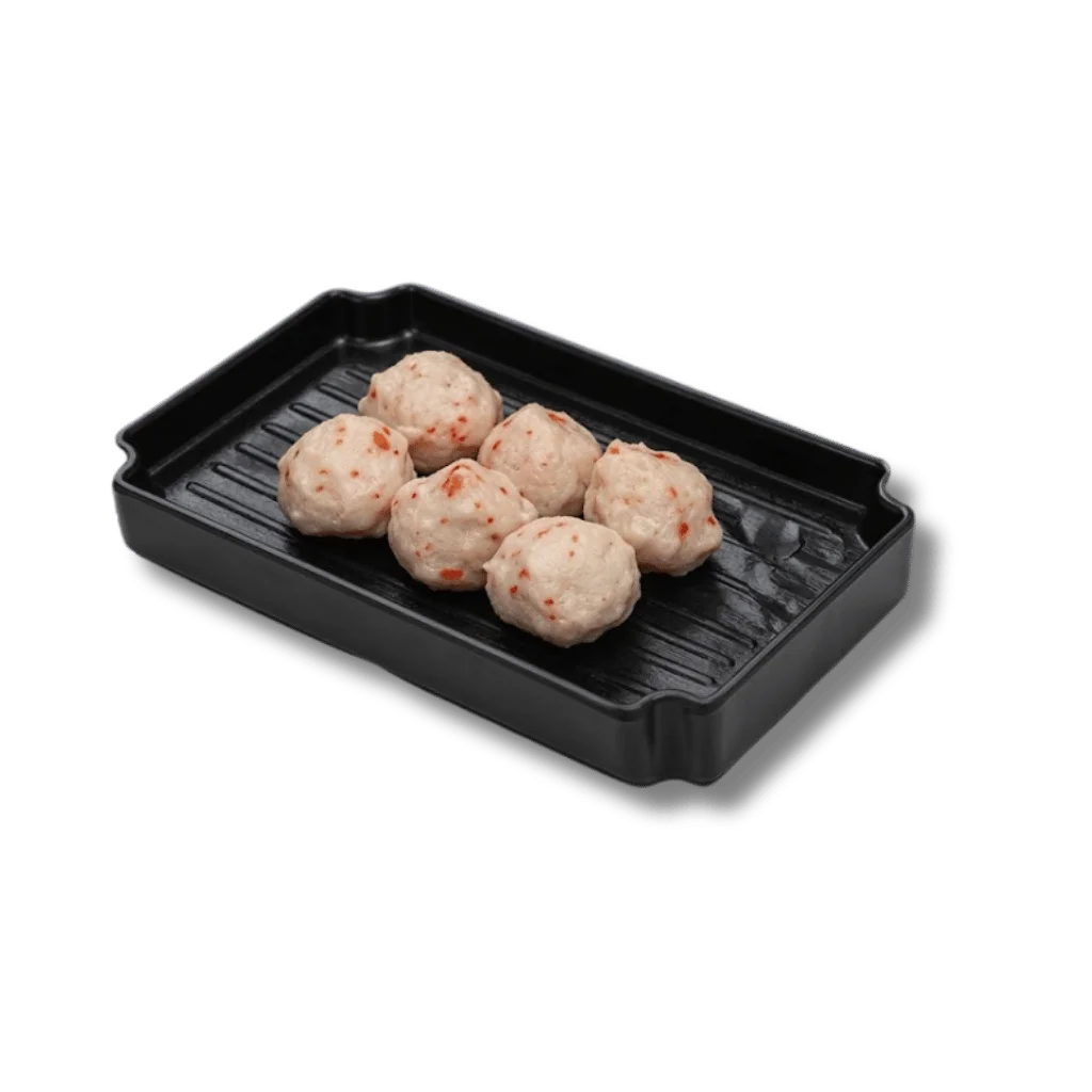 Six meatballs on a black grill plate.