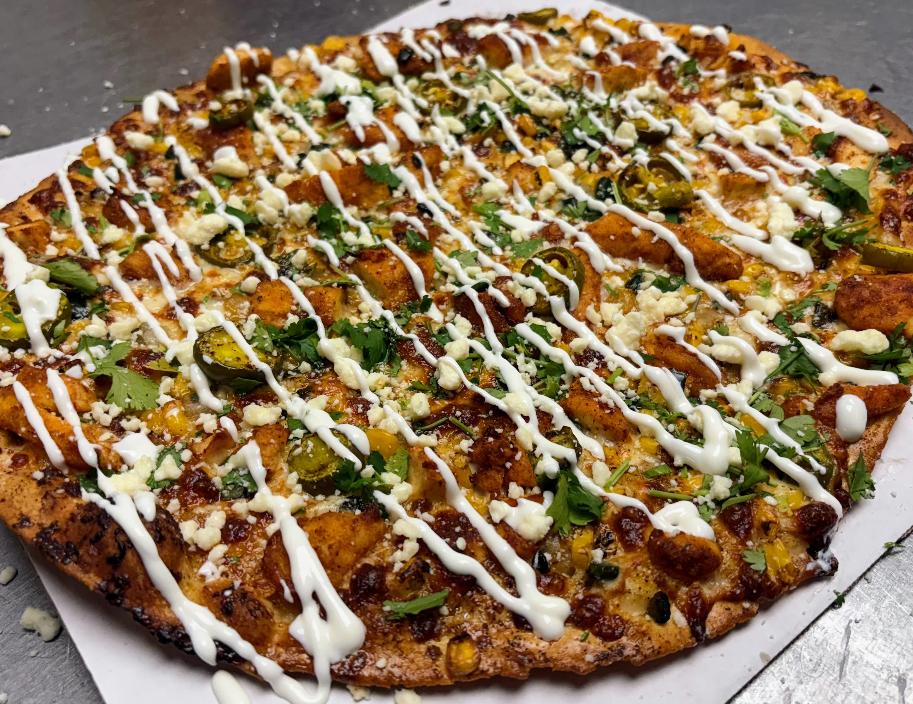 Spicy Indian-style flatbread topped with herbs and drizzled sauce