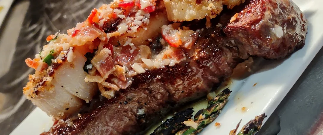 Grilled steak with savory topping and asparagus
