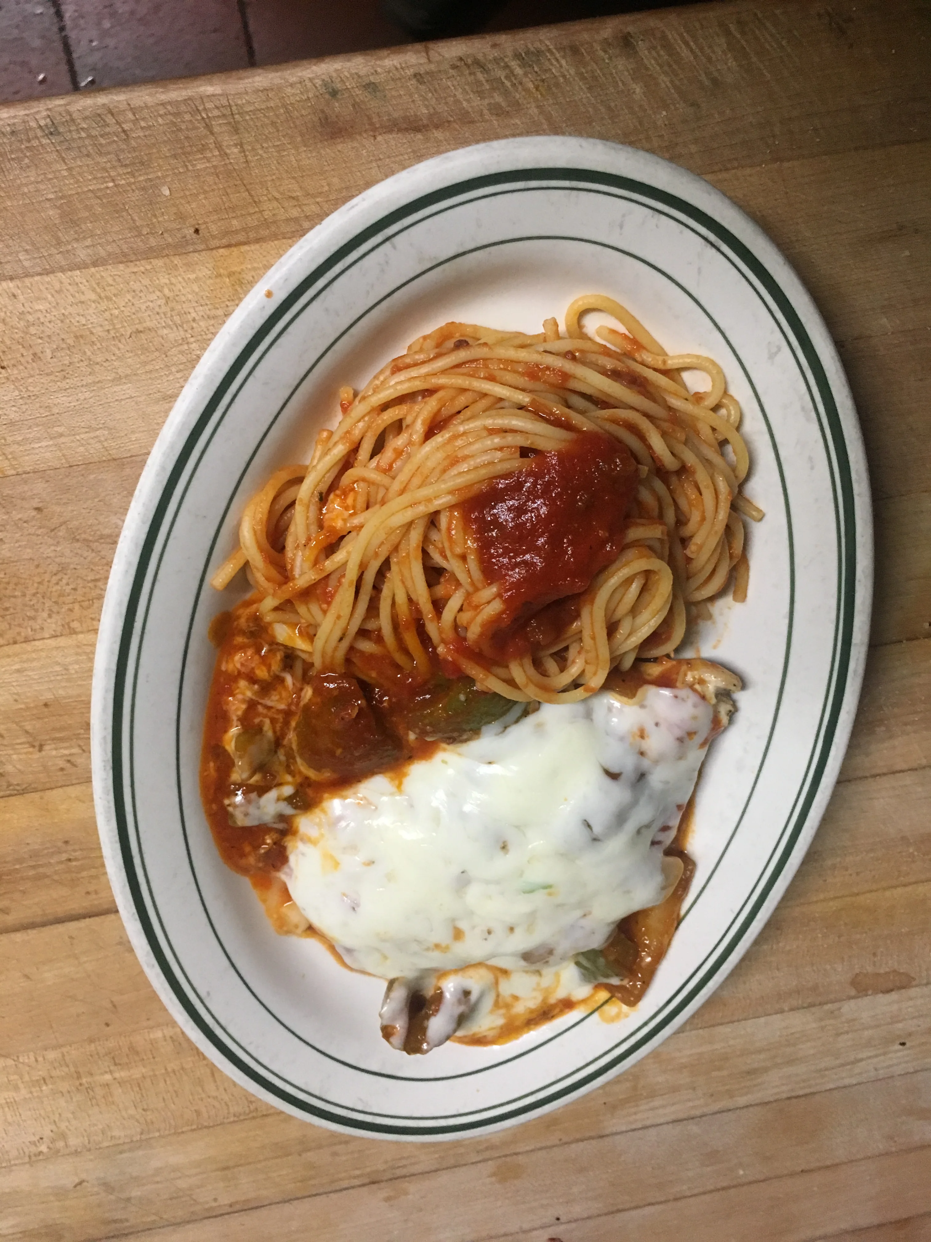 Italian spaghetti with marinara sauce and baked chicken parmesan