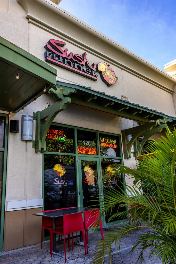 Exterior view of Sushi Runner restaurant with open sign