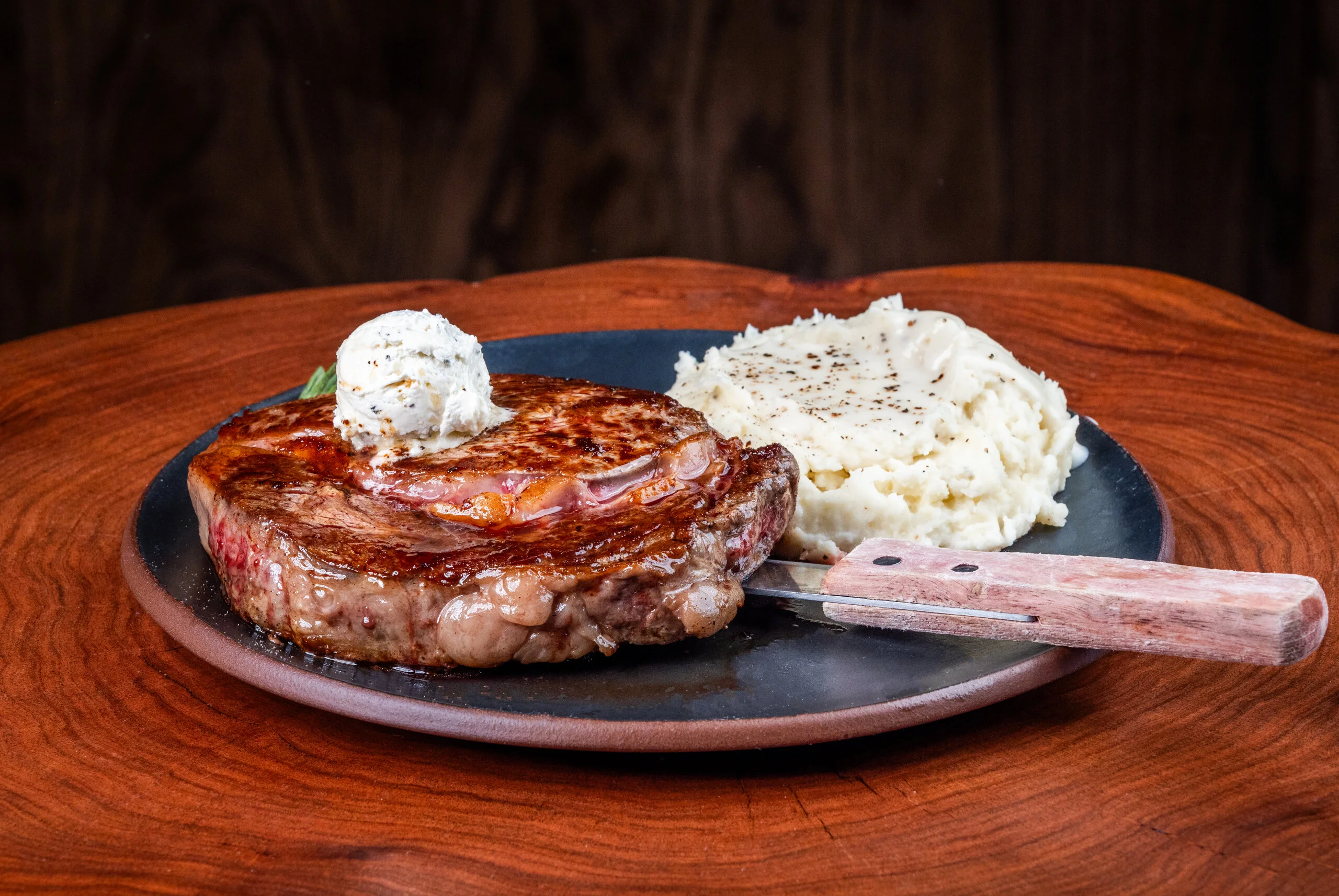 Juicy ribeye steak with garlic butter and creamy mashed potatoes