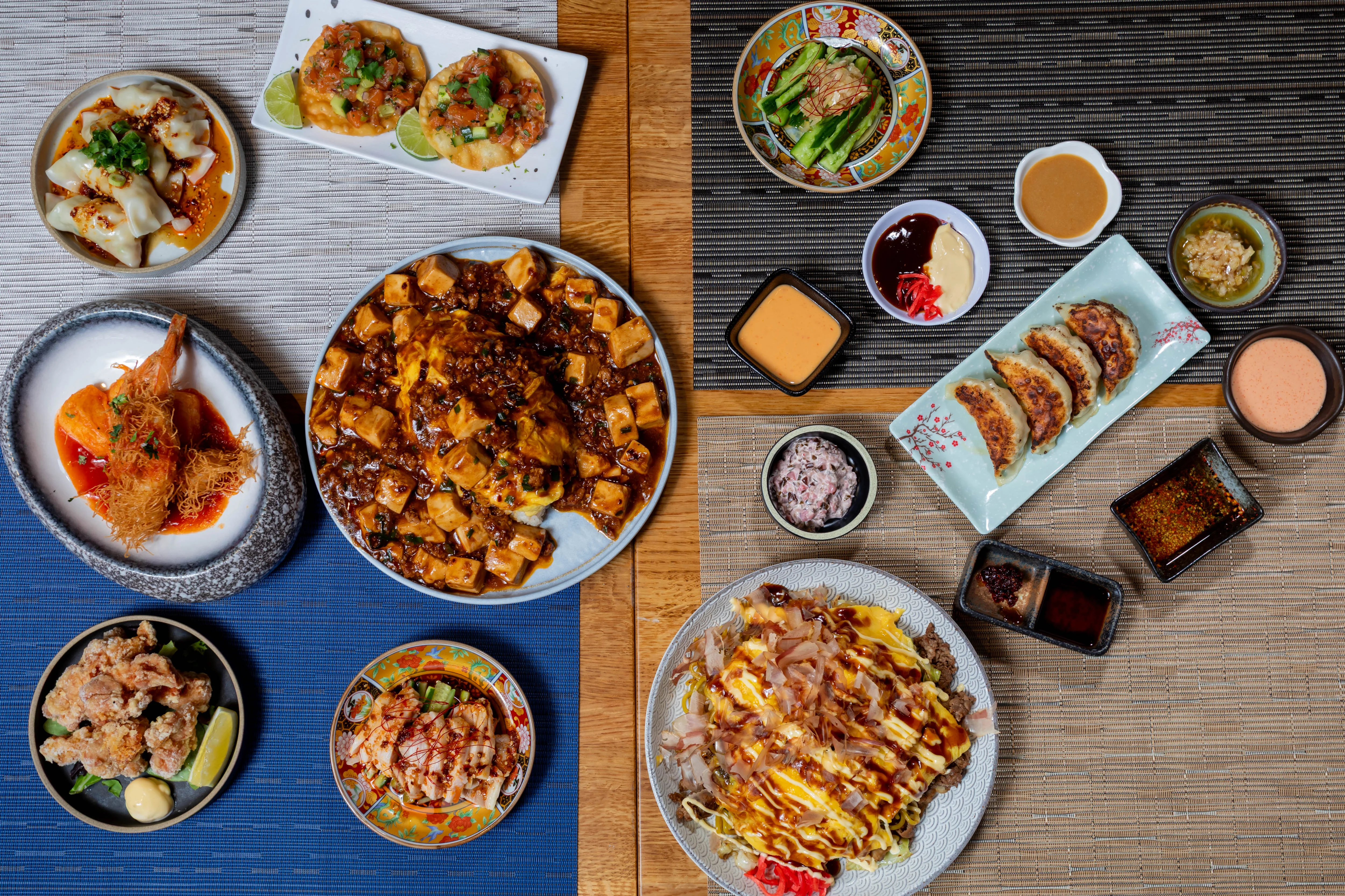 Assorted Asian dishes including dumplings and okonomiyaki