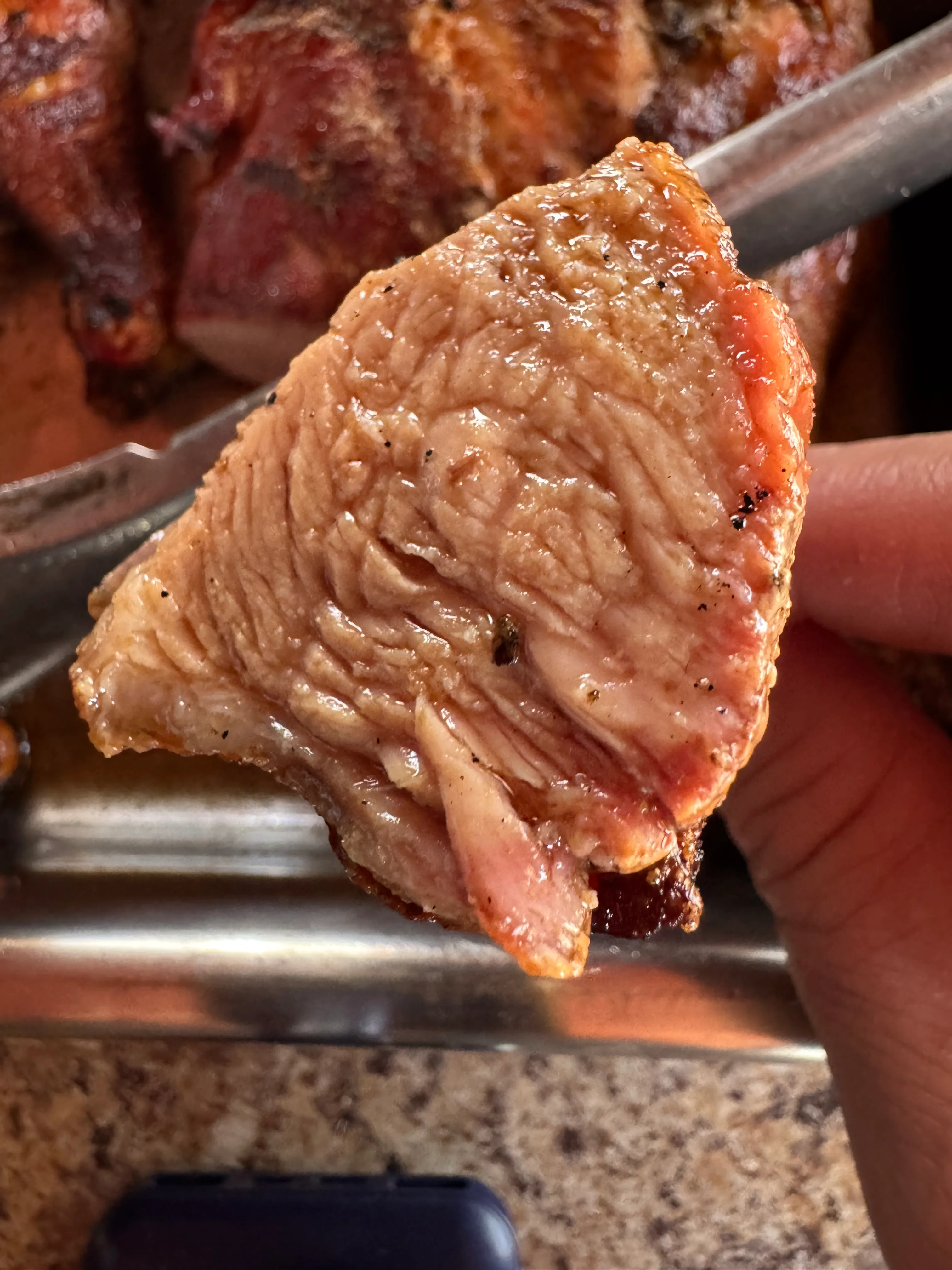 Juicy slice of roasted pork from a traditional barbecue