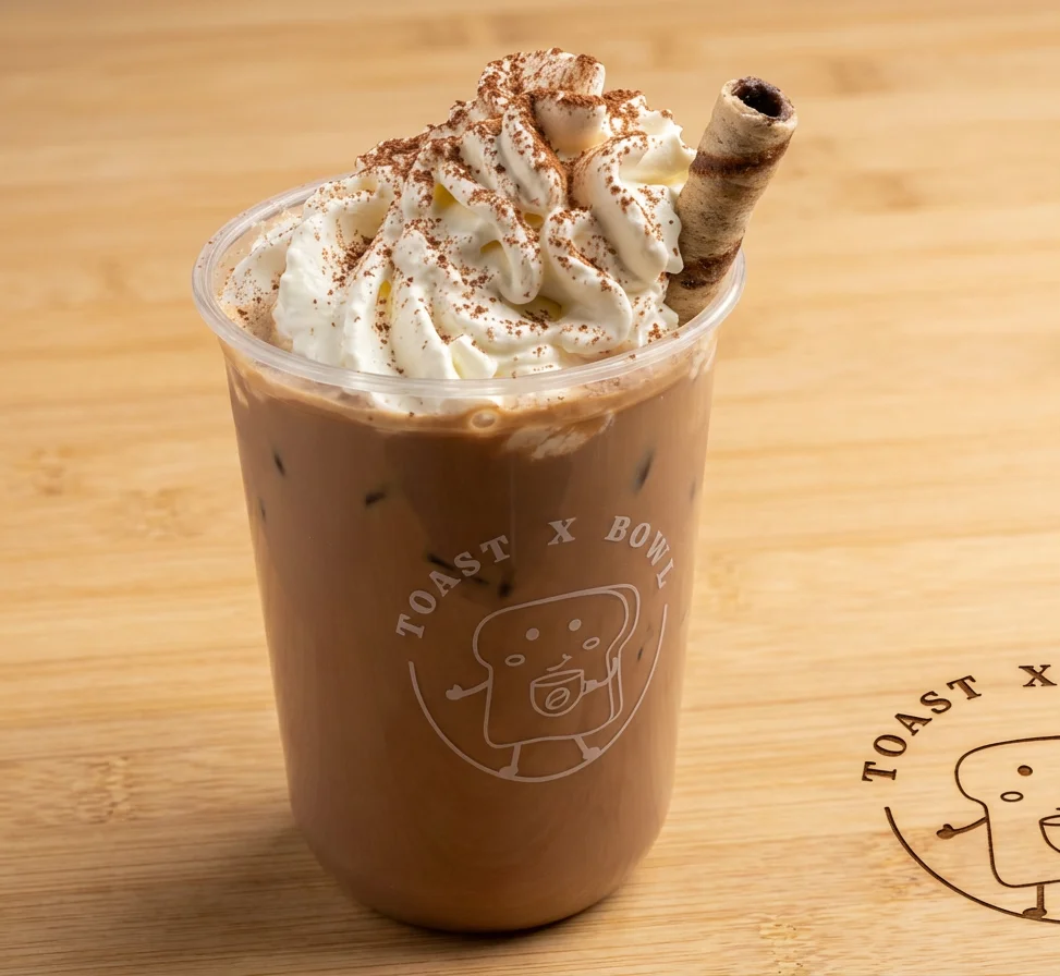 Iced mocha coffee topped with whipped cream and chocolate