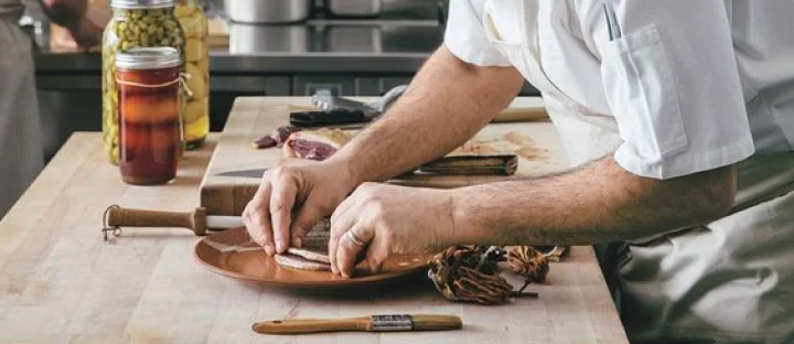 A restaurant chef preparing a dish